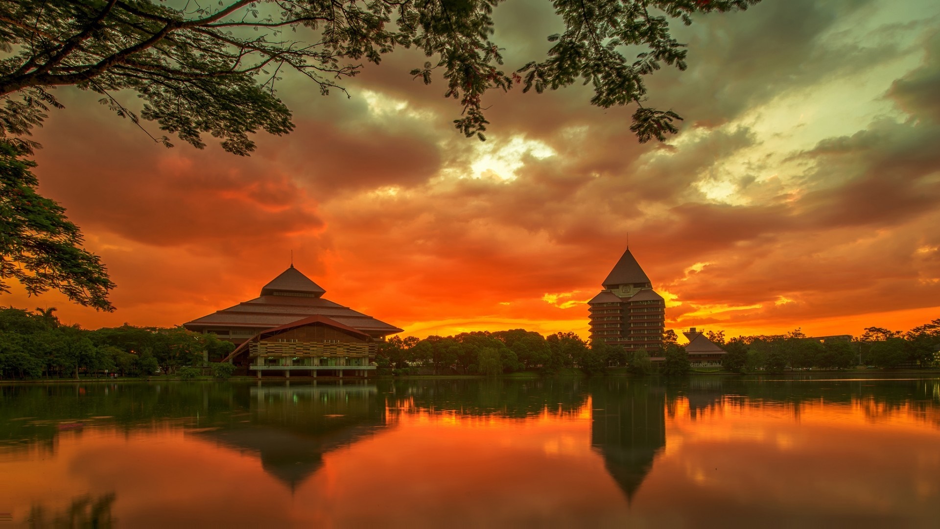 Sunset over lake with buildings and trees HD Wallpaper