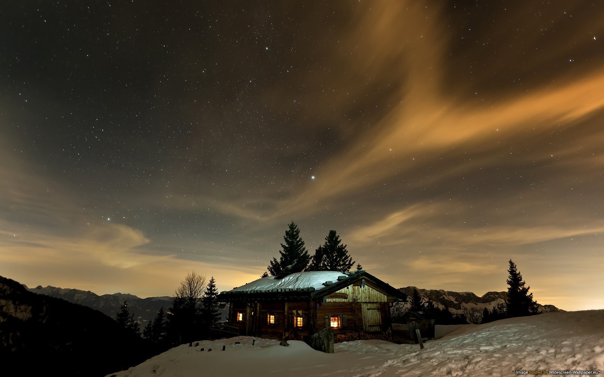 Wooden cabin under starry night sky in winter HD Wallpaper
