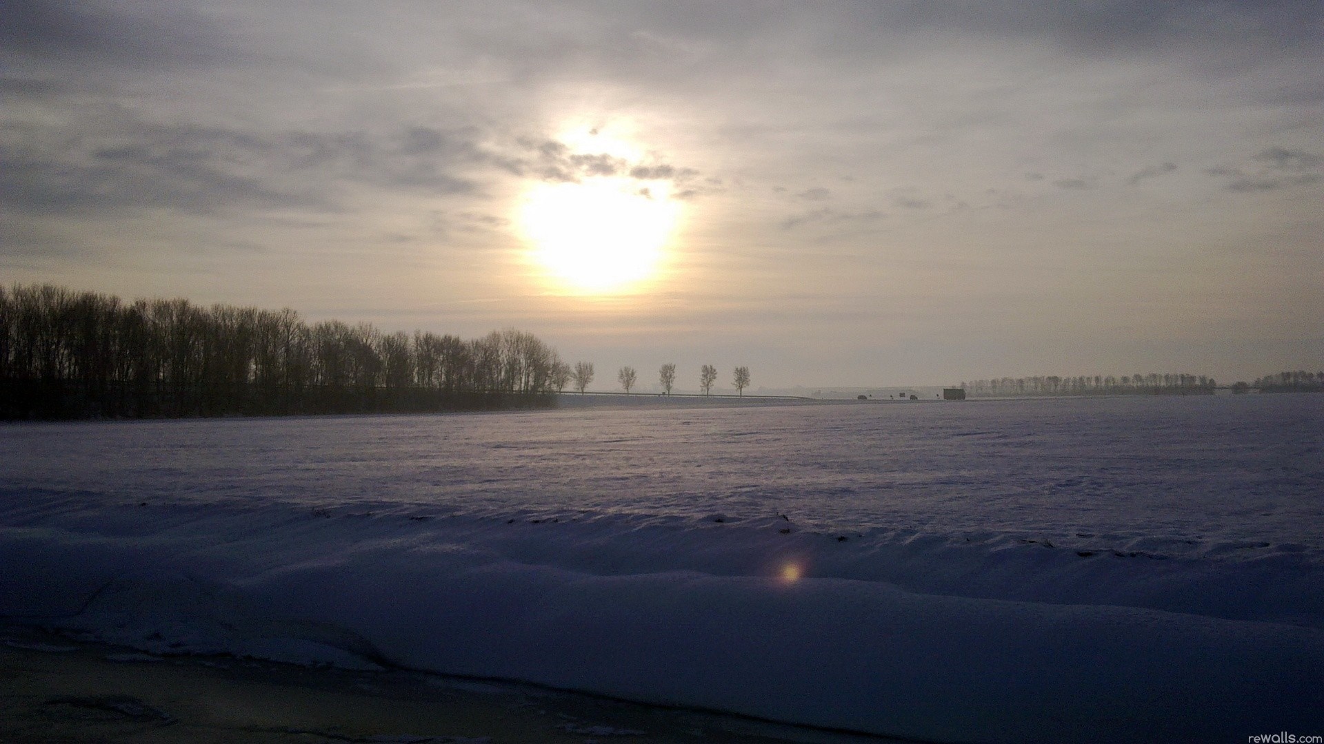 Winter landscape with sun over a snowy field HD Wallpaper
