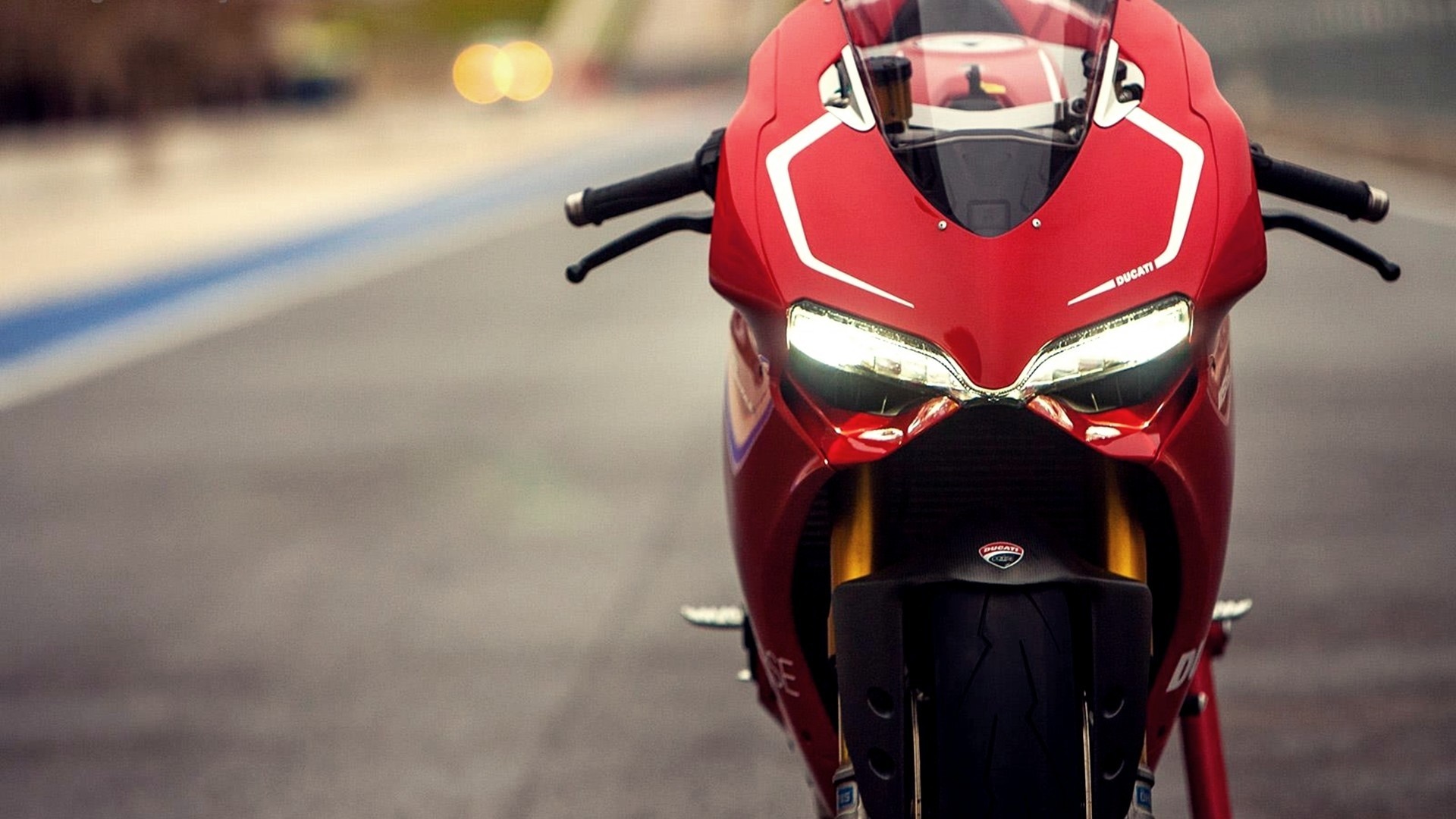 Red Ducati motorcycle on a race track HD Wallpaper