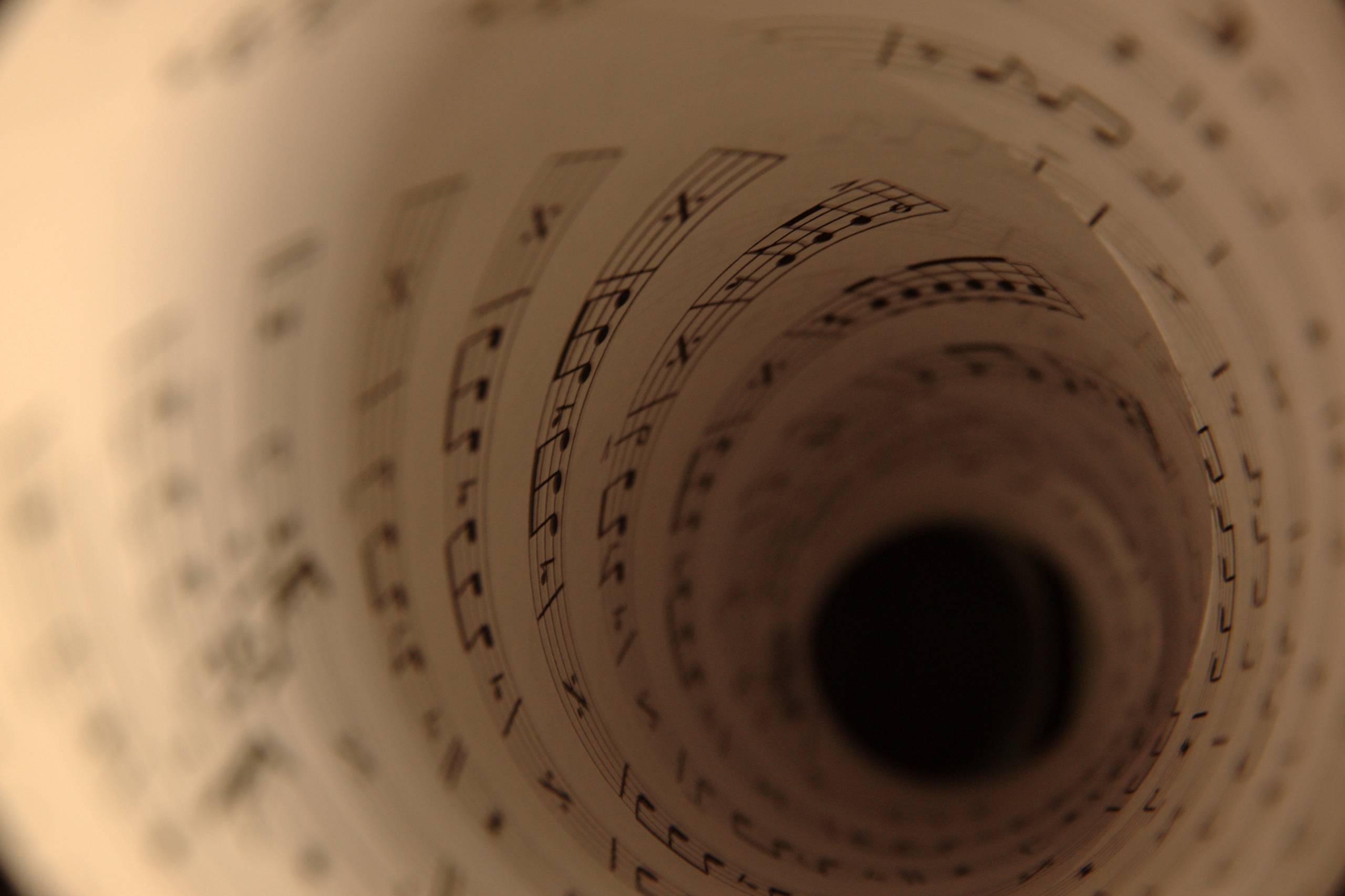 Rolled sheet music in a spiral tunnel effect HD Wallpaper