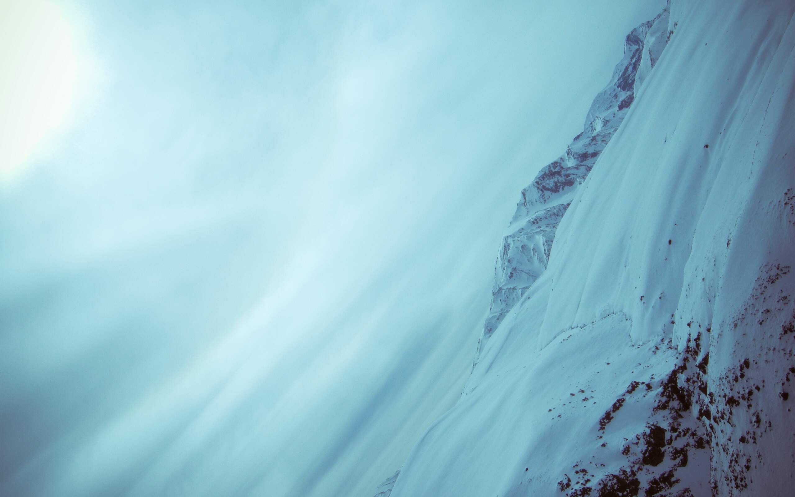 Snowy mountains under a bright sky HD Wallpaper