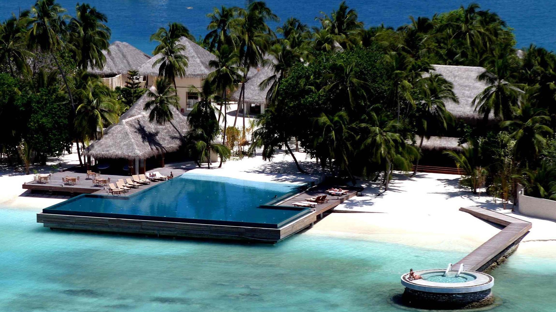 Tropical resort with infinity pool and overwater jacuzzi HD Wallpaper