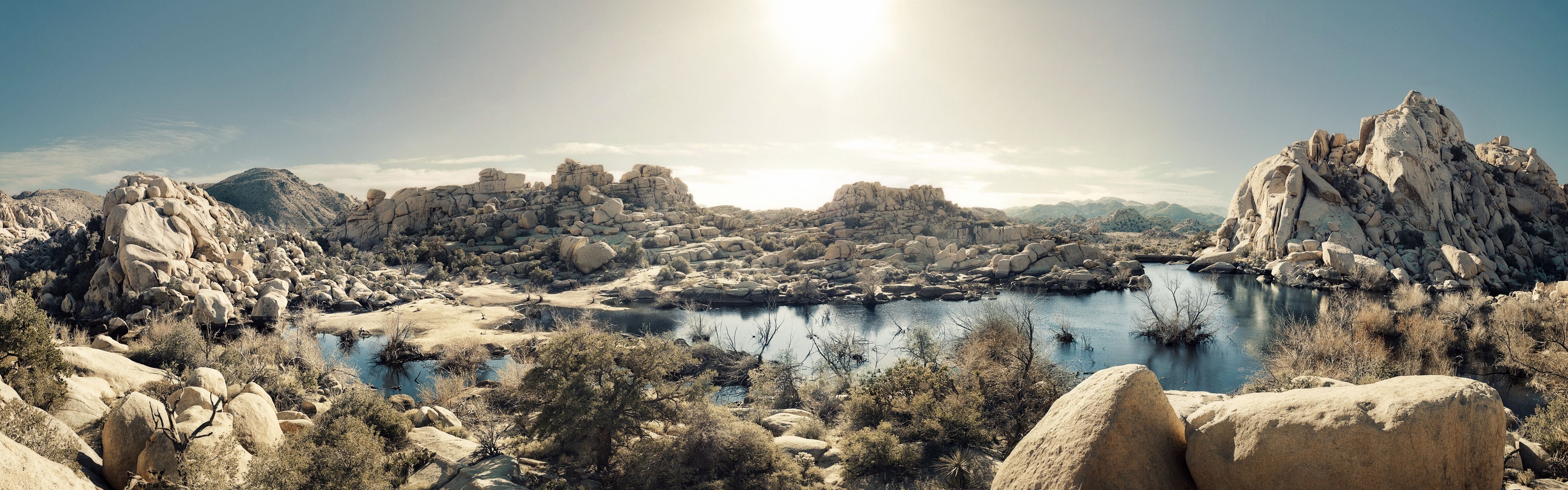 Panoramic view of a desert lake surrounded by rock formations HD Wallpaper