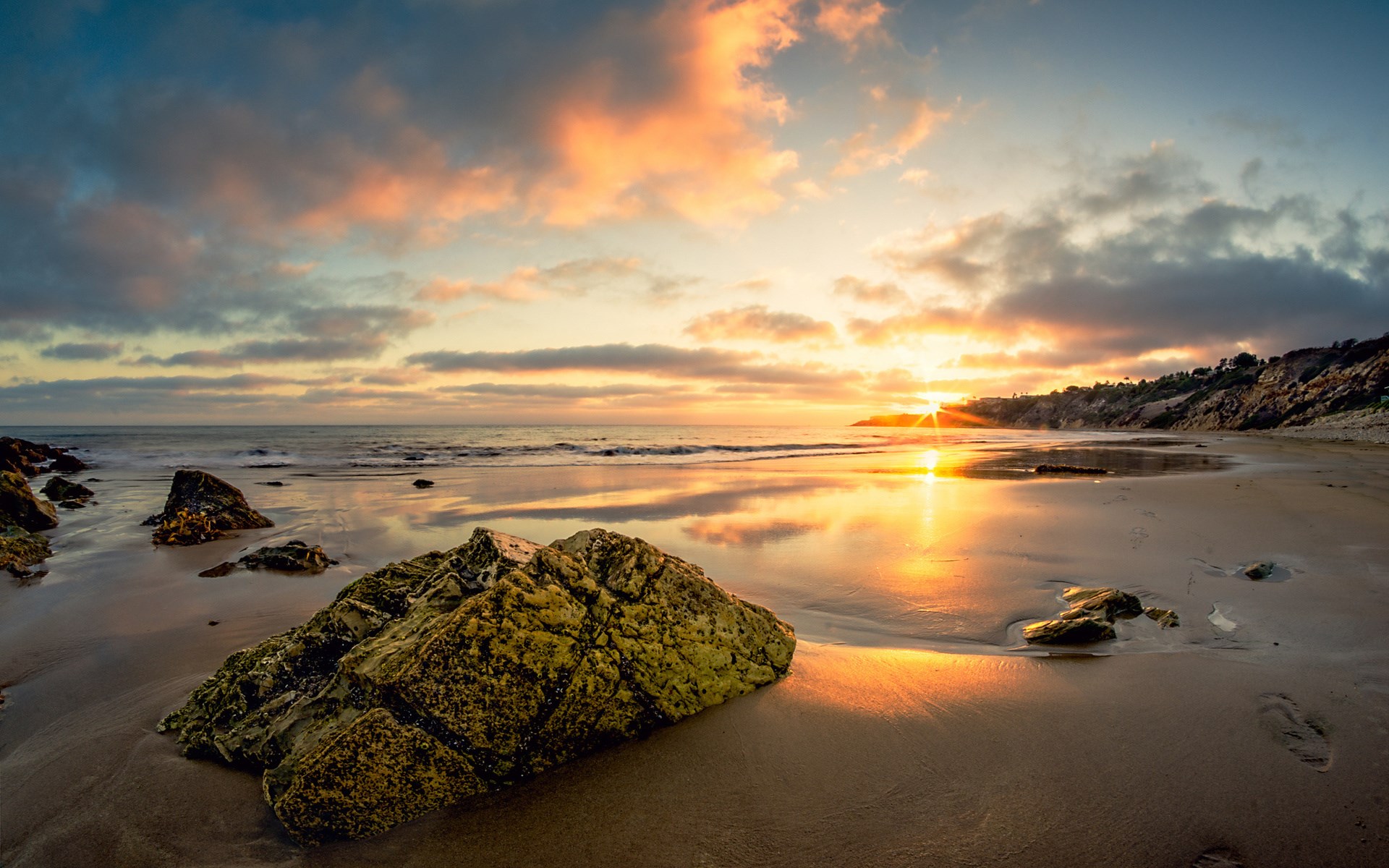 Sunset over a rocky beach with ocean waves HD Wallpaper