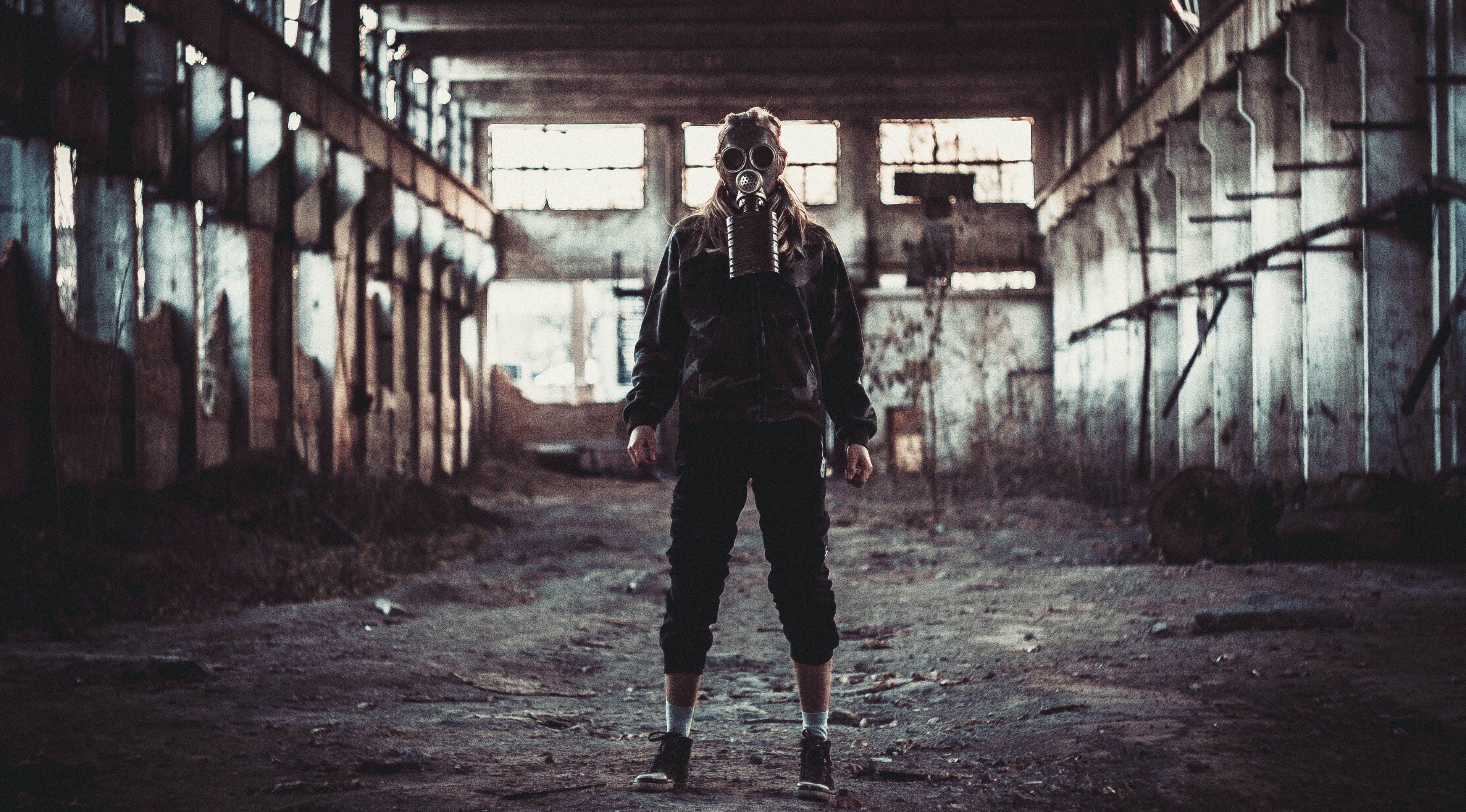 Person wearing a gas mask in an abandoned building HD Wallpaper