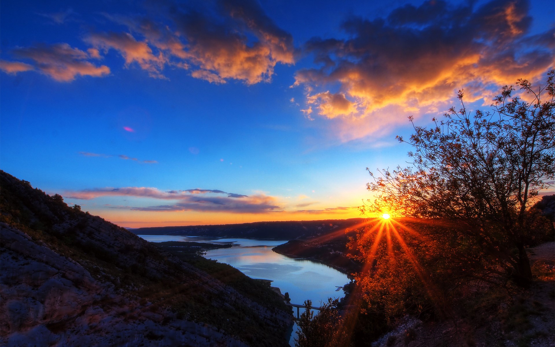Sunset over a river valley with mountains and clouds HD Wallpaper