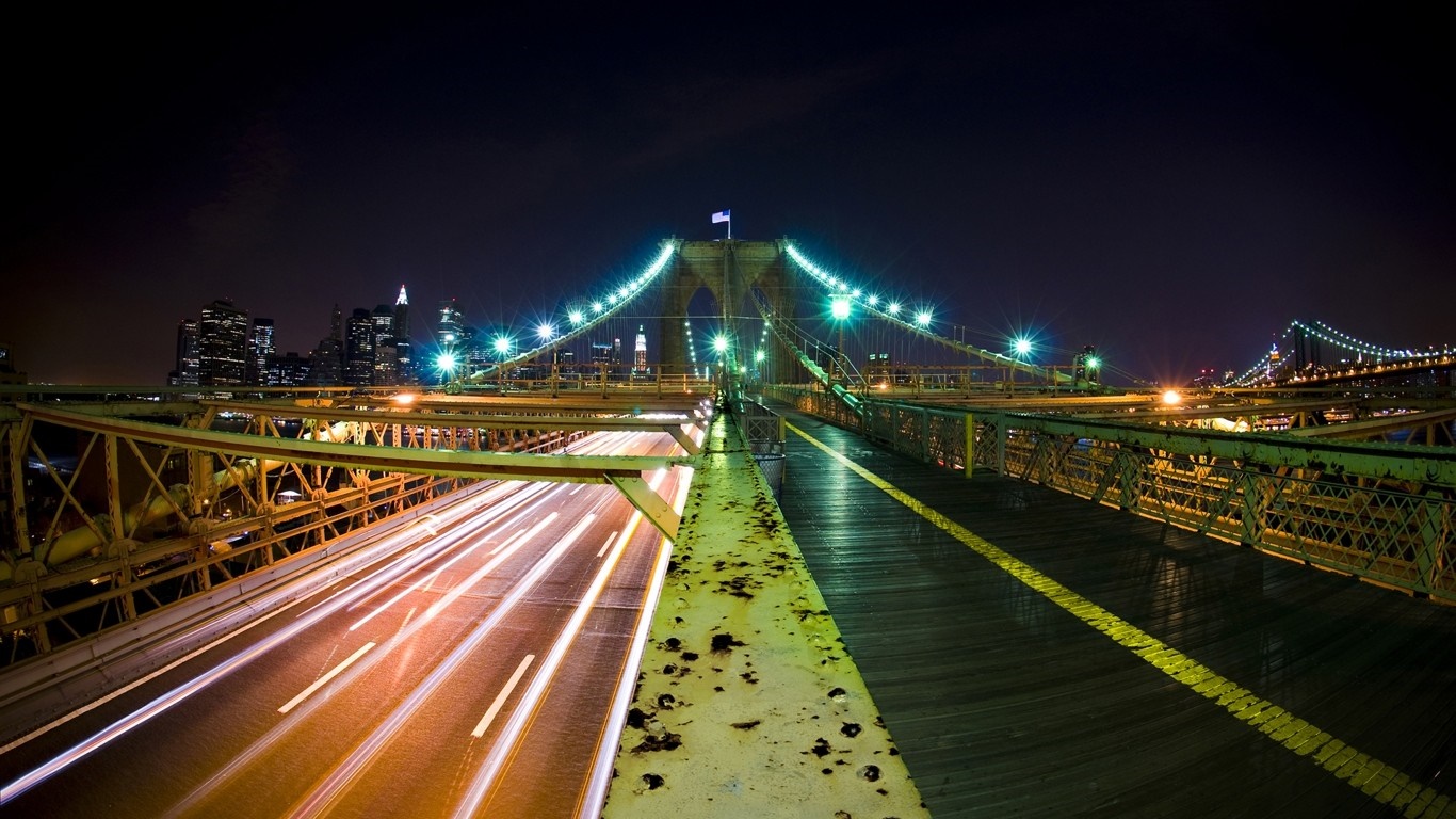 Brooklyn Bridge at night with light trails and cityscape HD Wallpaper