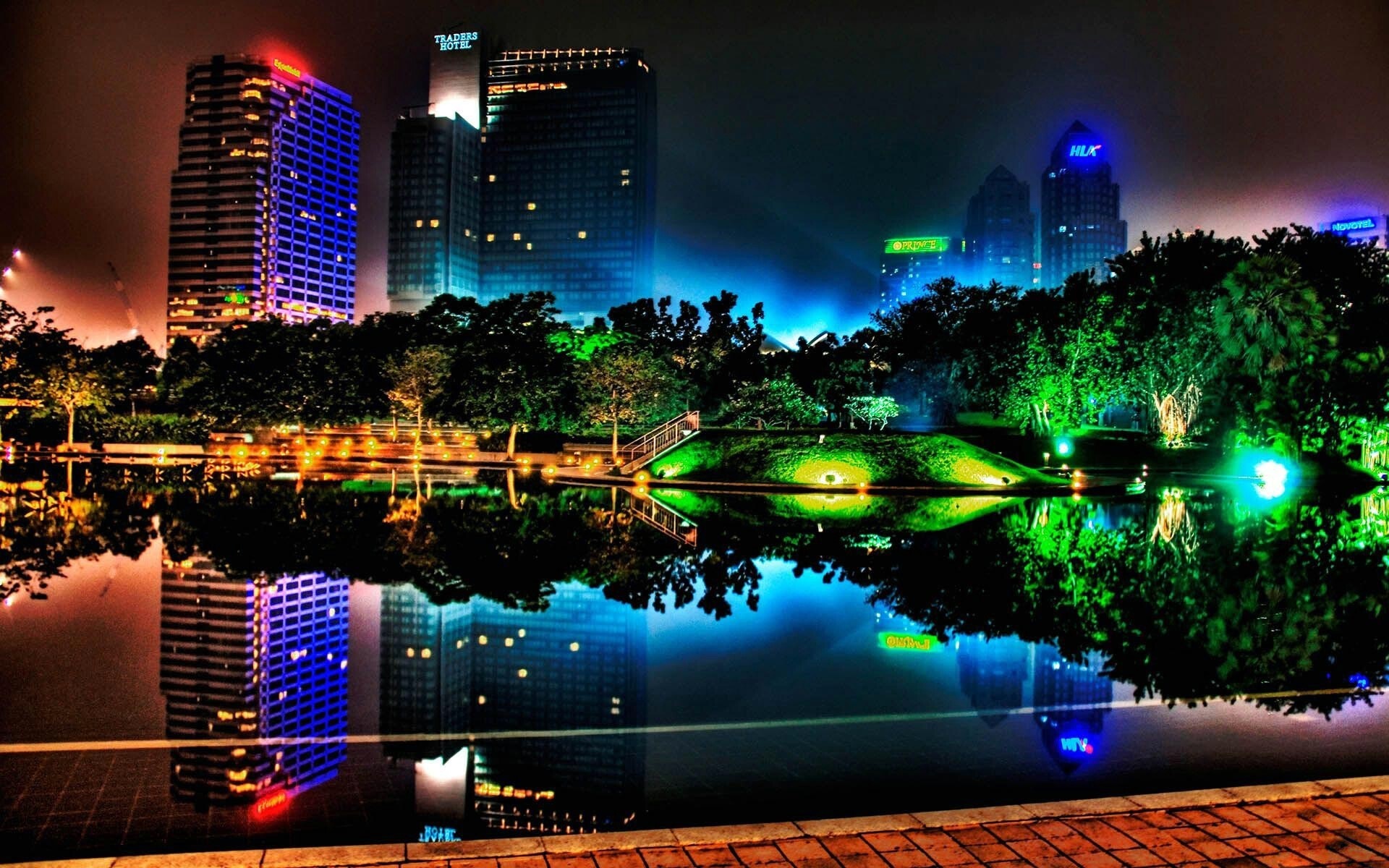 Colorful cityscape at night with reflections in water HD Wallpaper