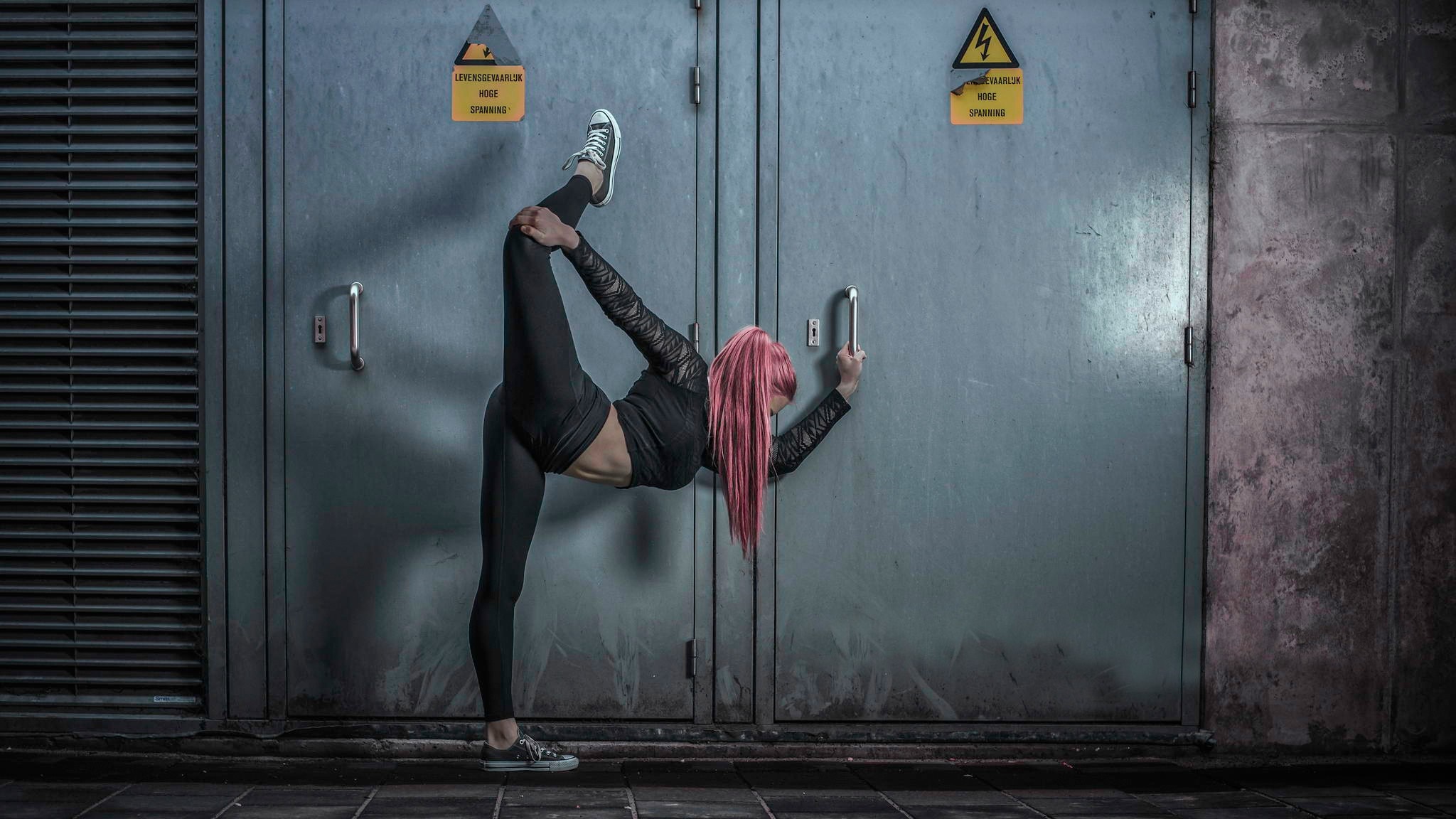 Woman with pink hair performing a dance move HD Wallpaper