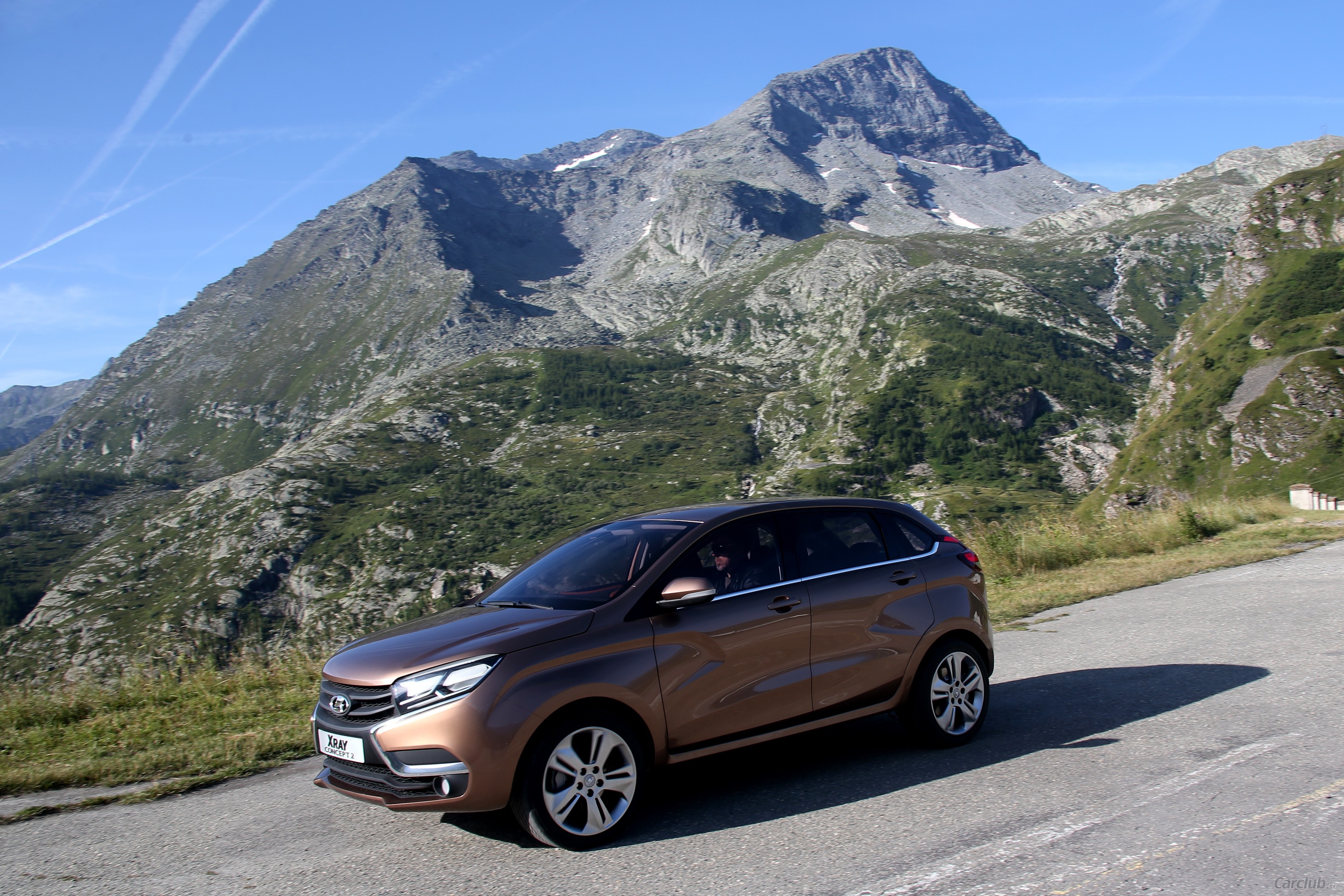 Brown LADA XRAY car on a mountain road HD Wallpaper