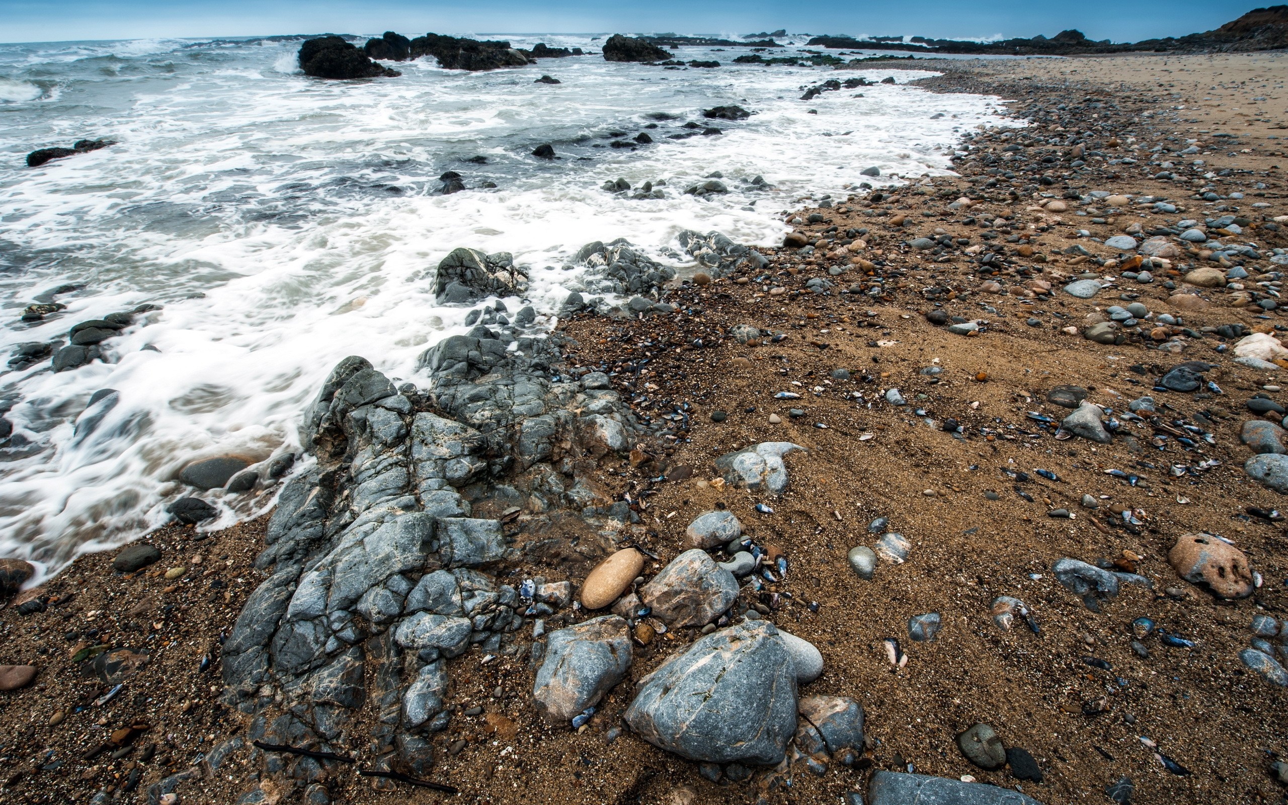 Rocky shore with waves crashing on the beach HD Wallpaper