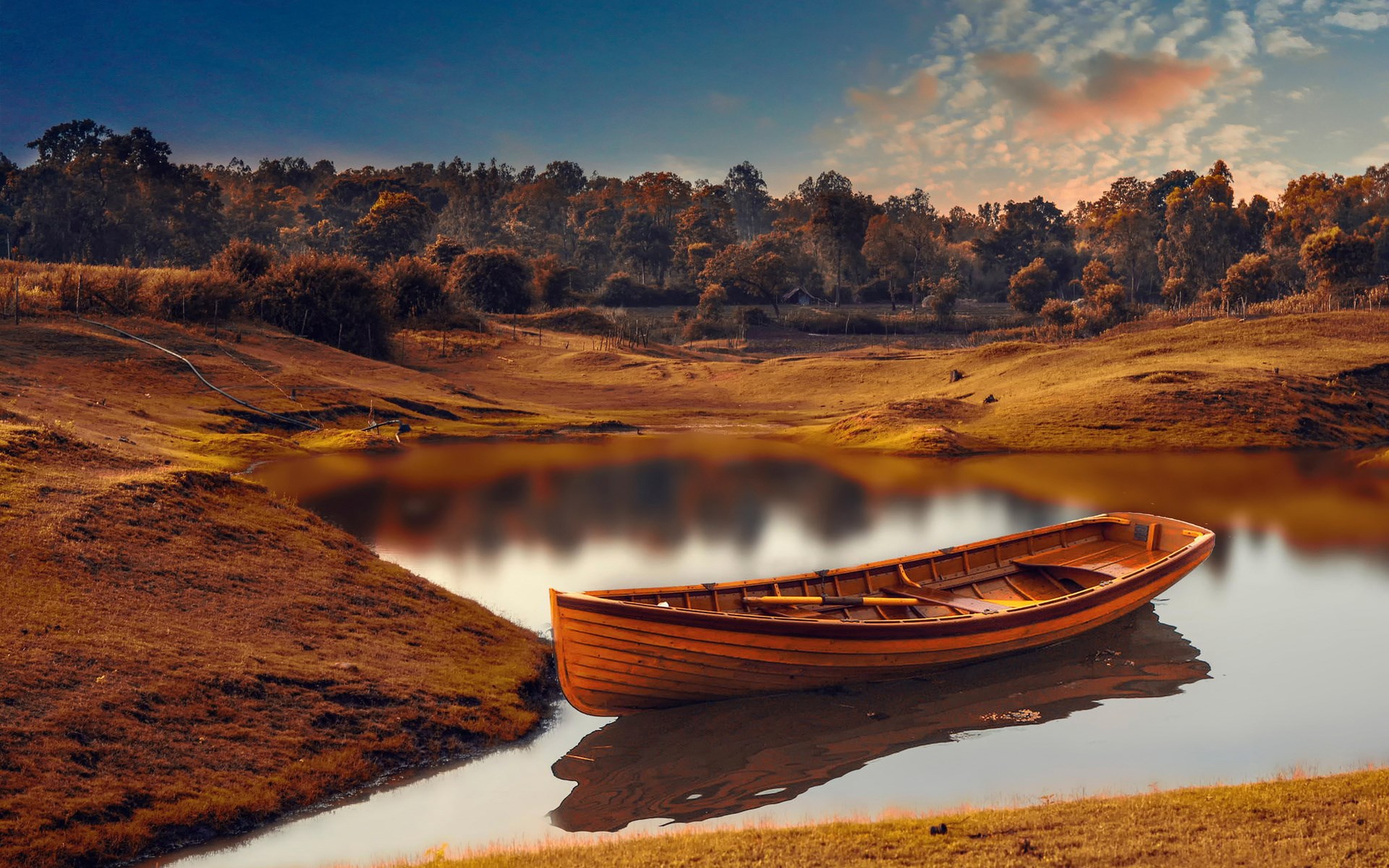 Wooden boat on a calm lake at sunset HD Wallpaper