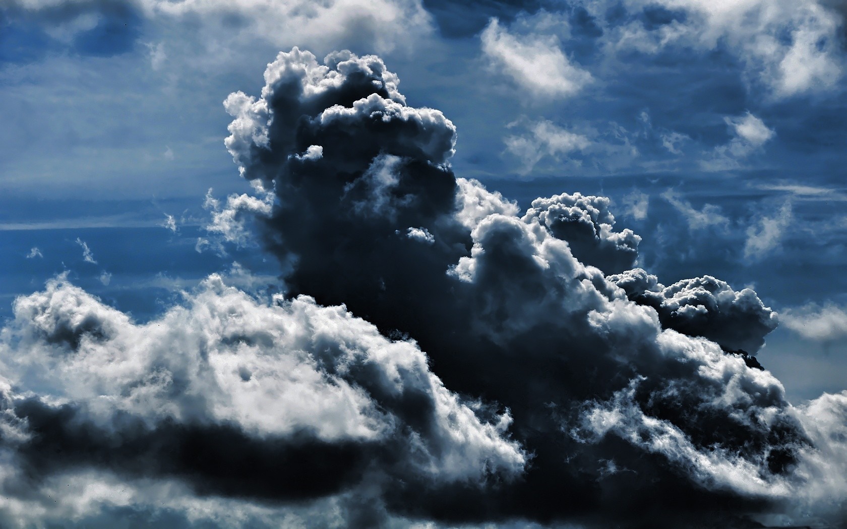 Dark storm clouds in a blue sky HD Wallpaper
