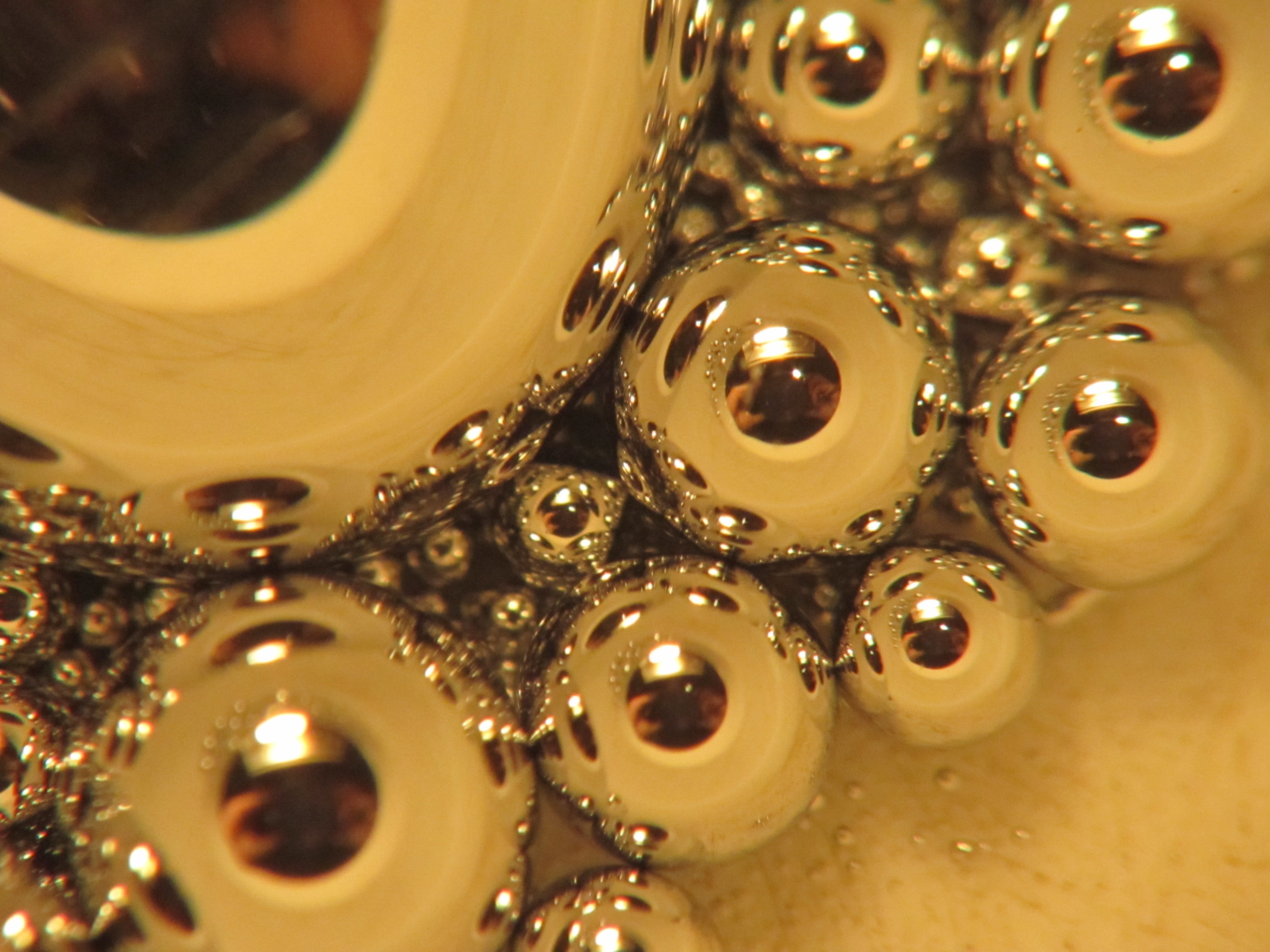 Close-up of metallic beads reflecting light HD Wallpaper