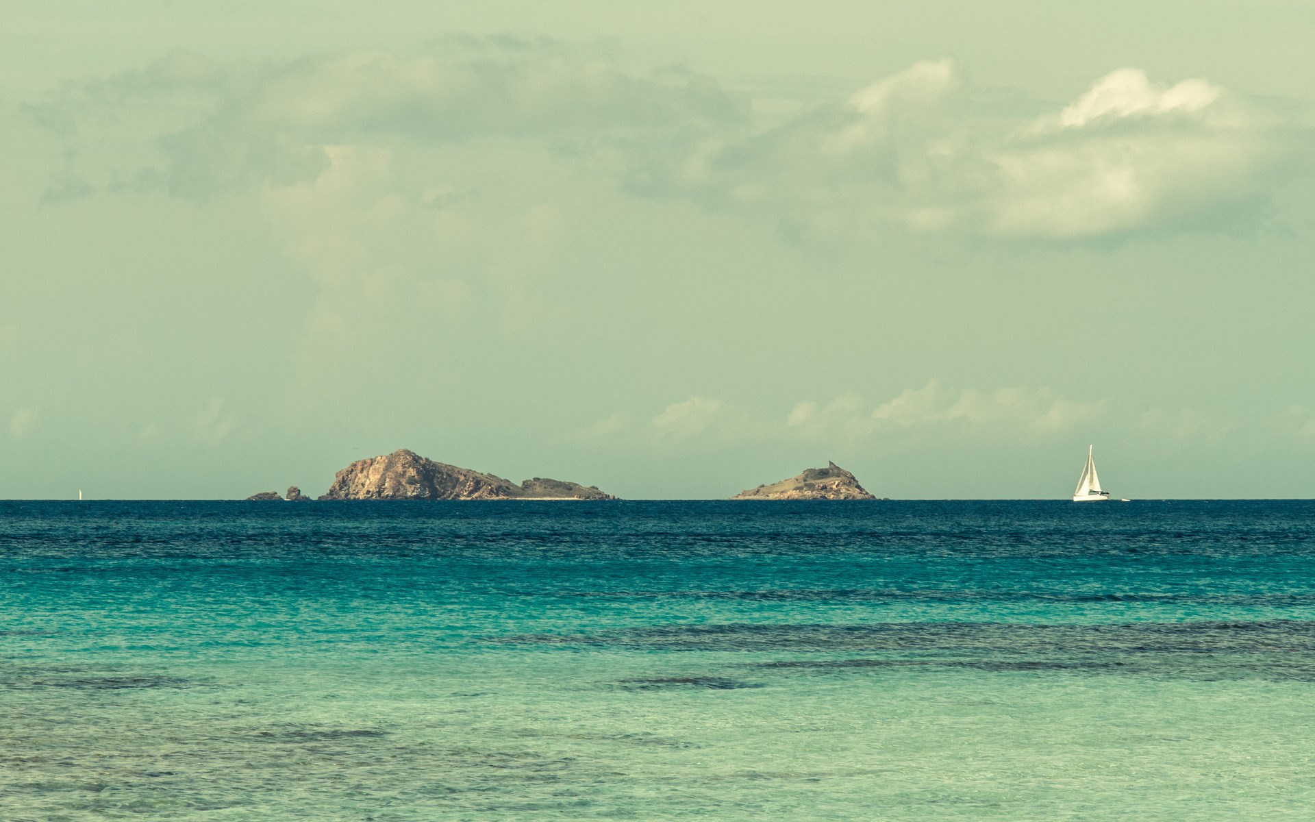 Sailboat near islands in the ocean HD Wallpaper