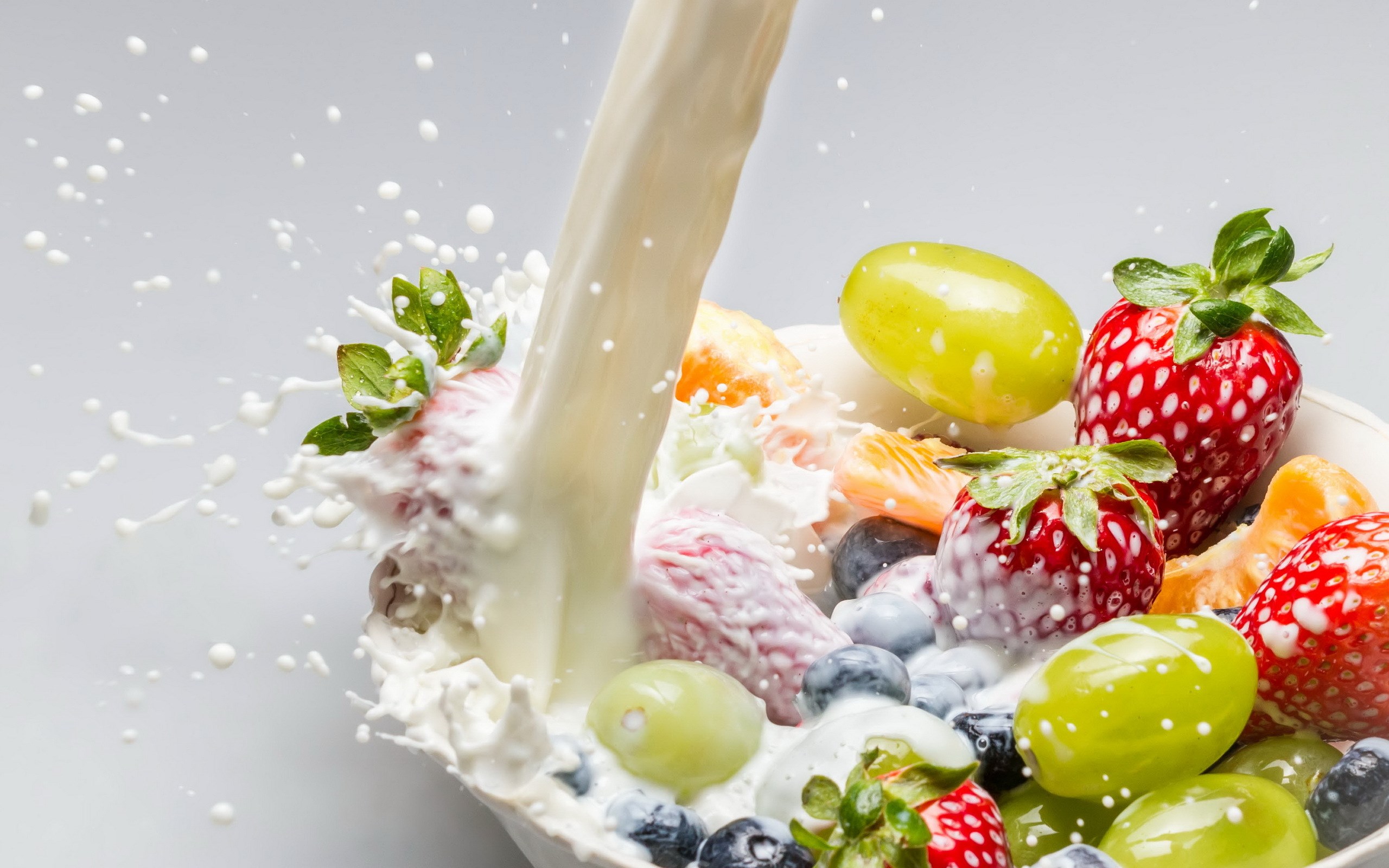 Milk Pouring Over Fruit Salad in a Bowl HD Wallpaper