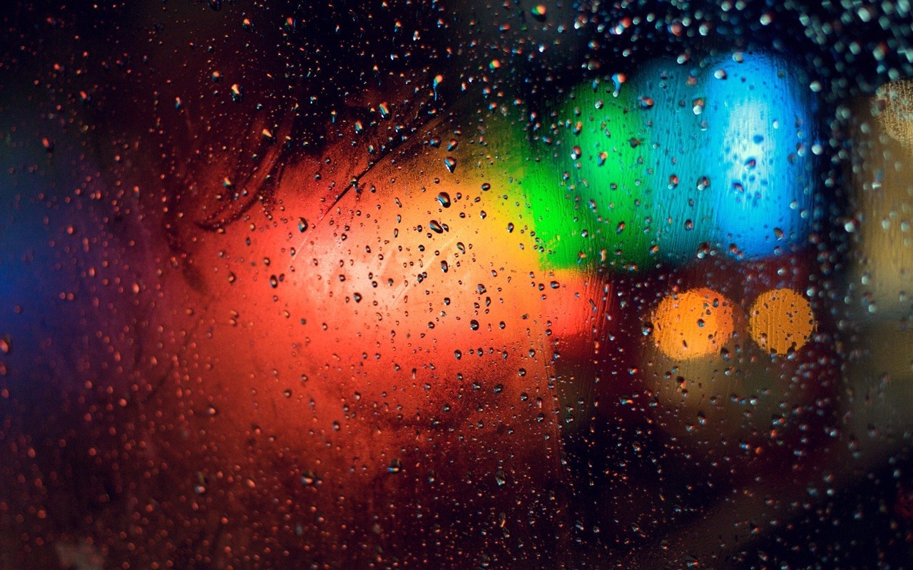 Colorful bokeh lights through water drops on glass HD Wallpaper