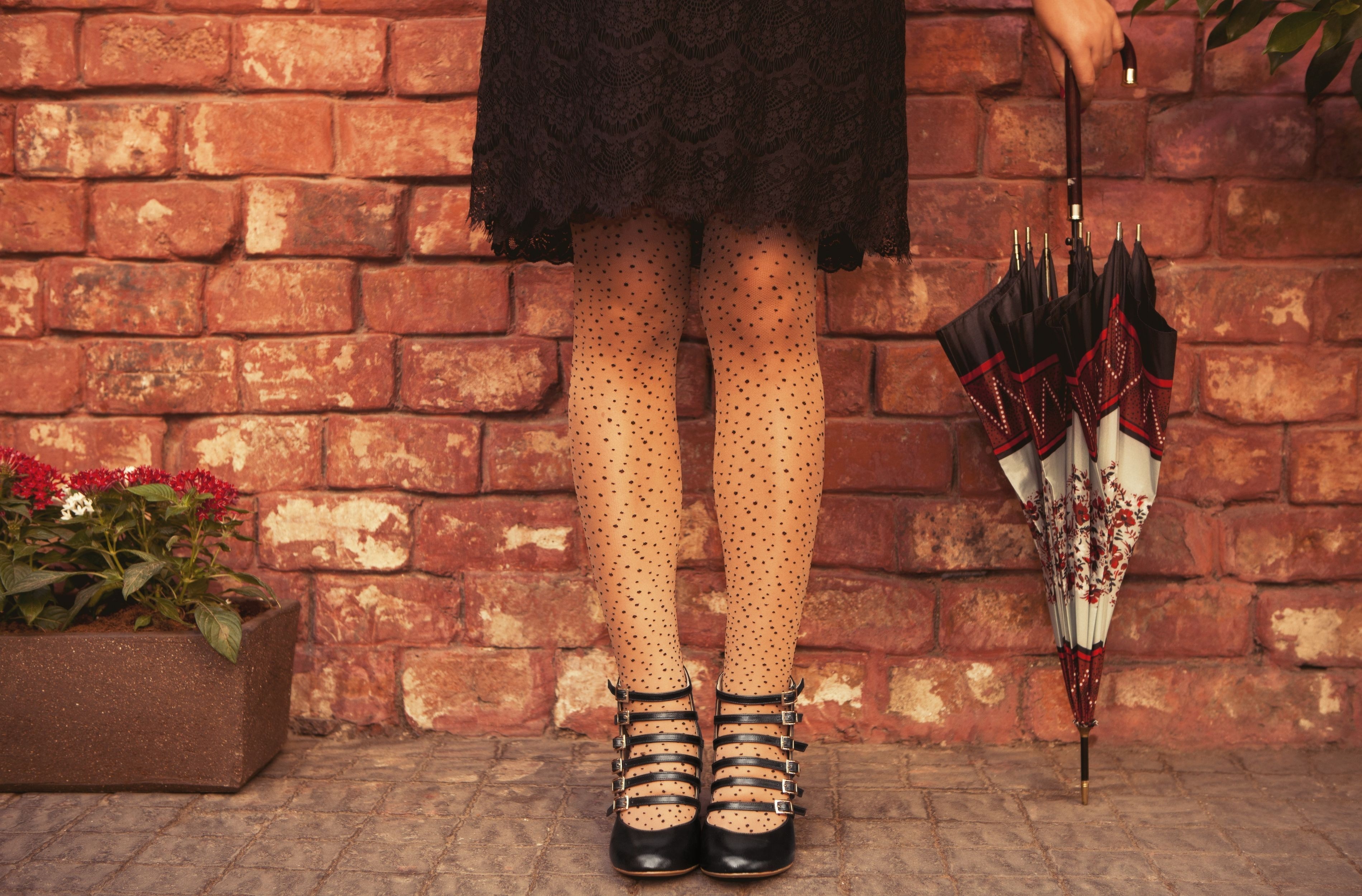 Woman in polka dot tights holding an umbrella HD Wallpaper