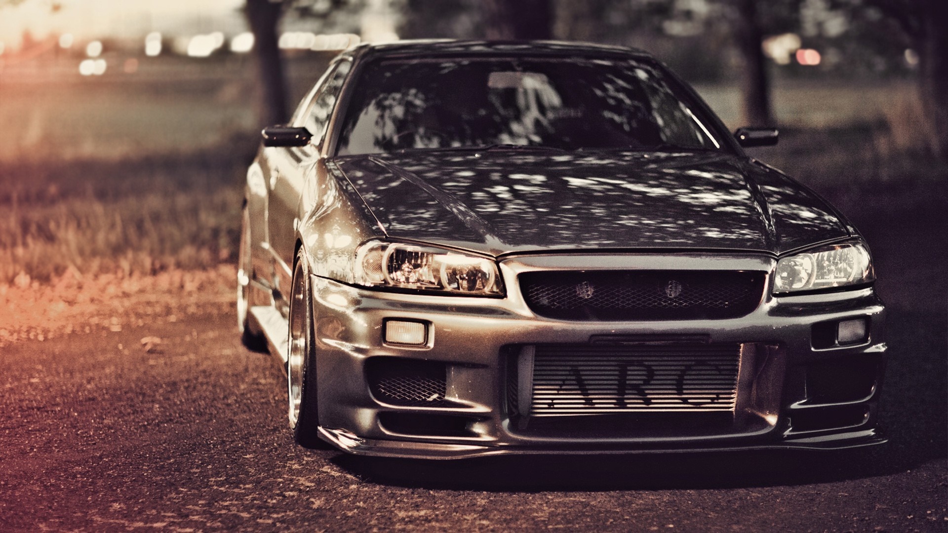 Nissan Skyline R34 GT-R parked on asphalt HD Wallpaper