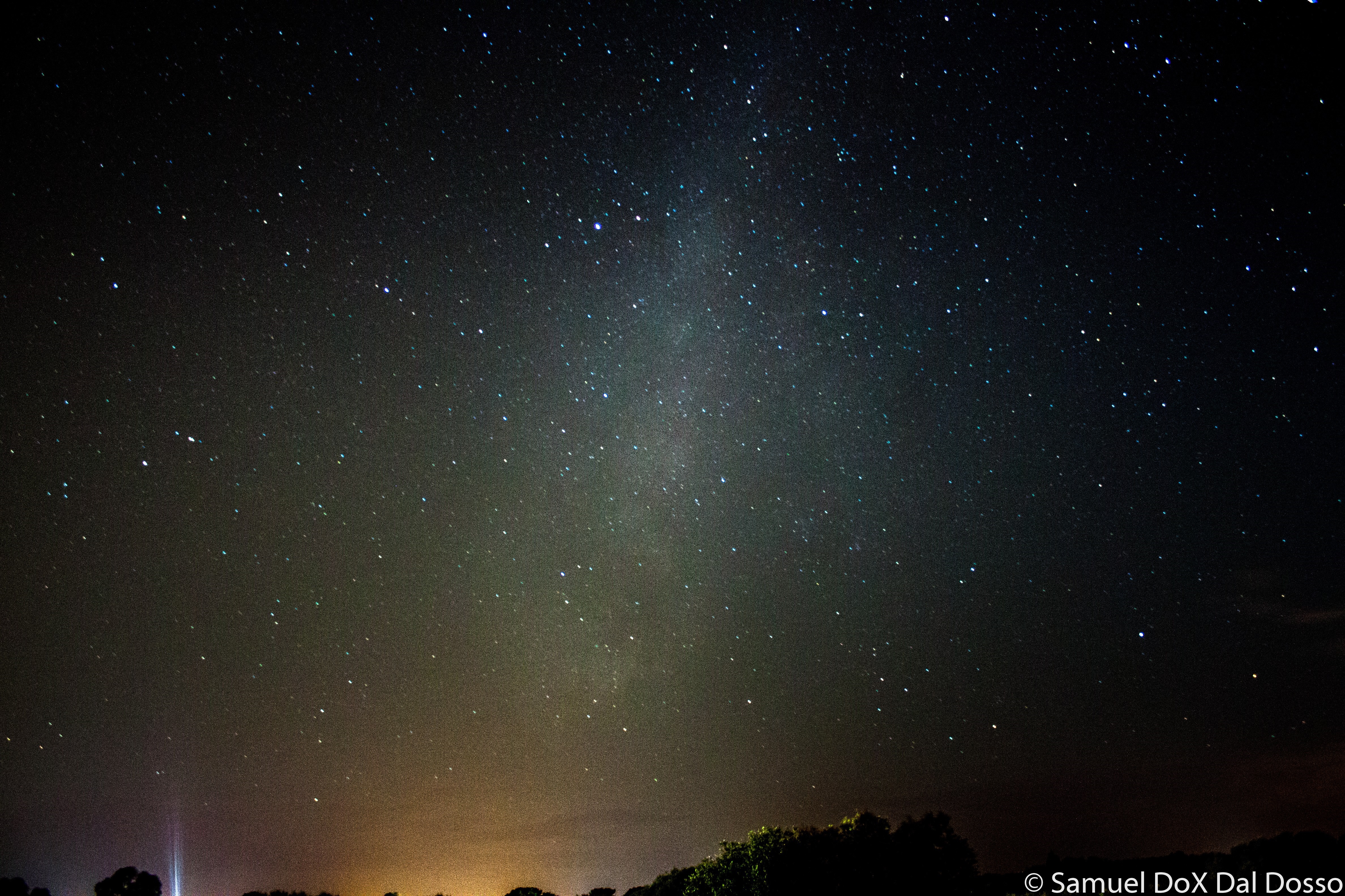 Milky Way galaxy in the night sky over a silhouetted landscape HD Wallpaper