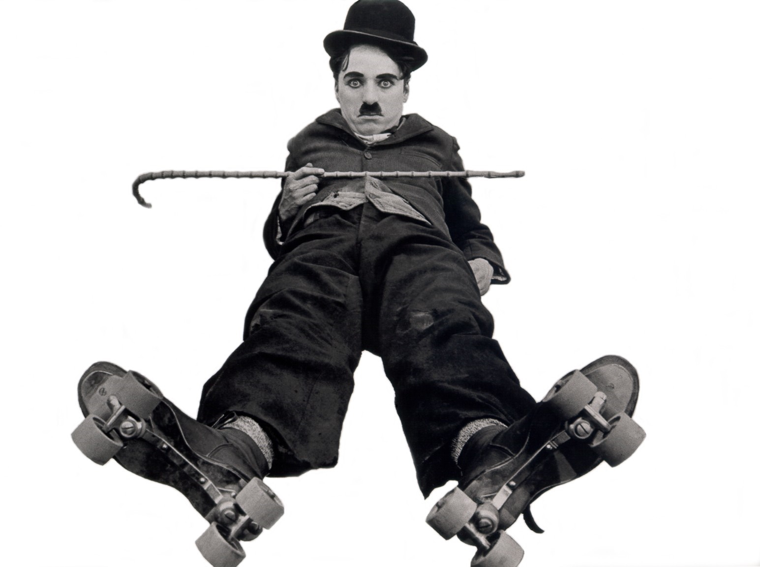 Charlie Chaplin as The Tramp on roller skates HD Wallpaper