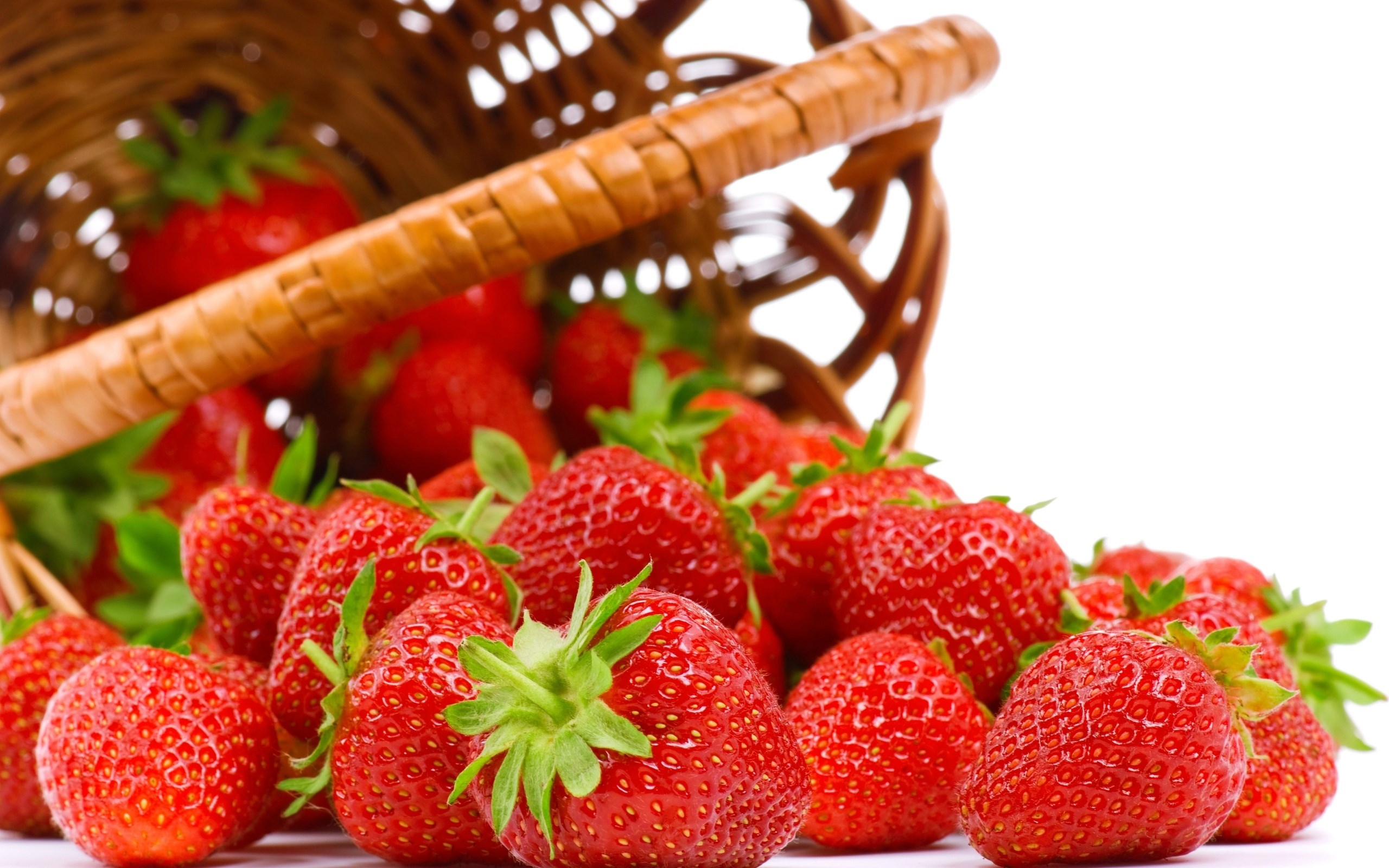 Strawberries spilling from a basket HD Wallpaper