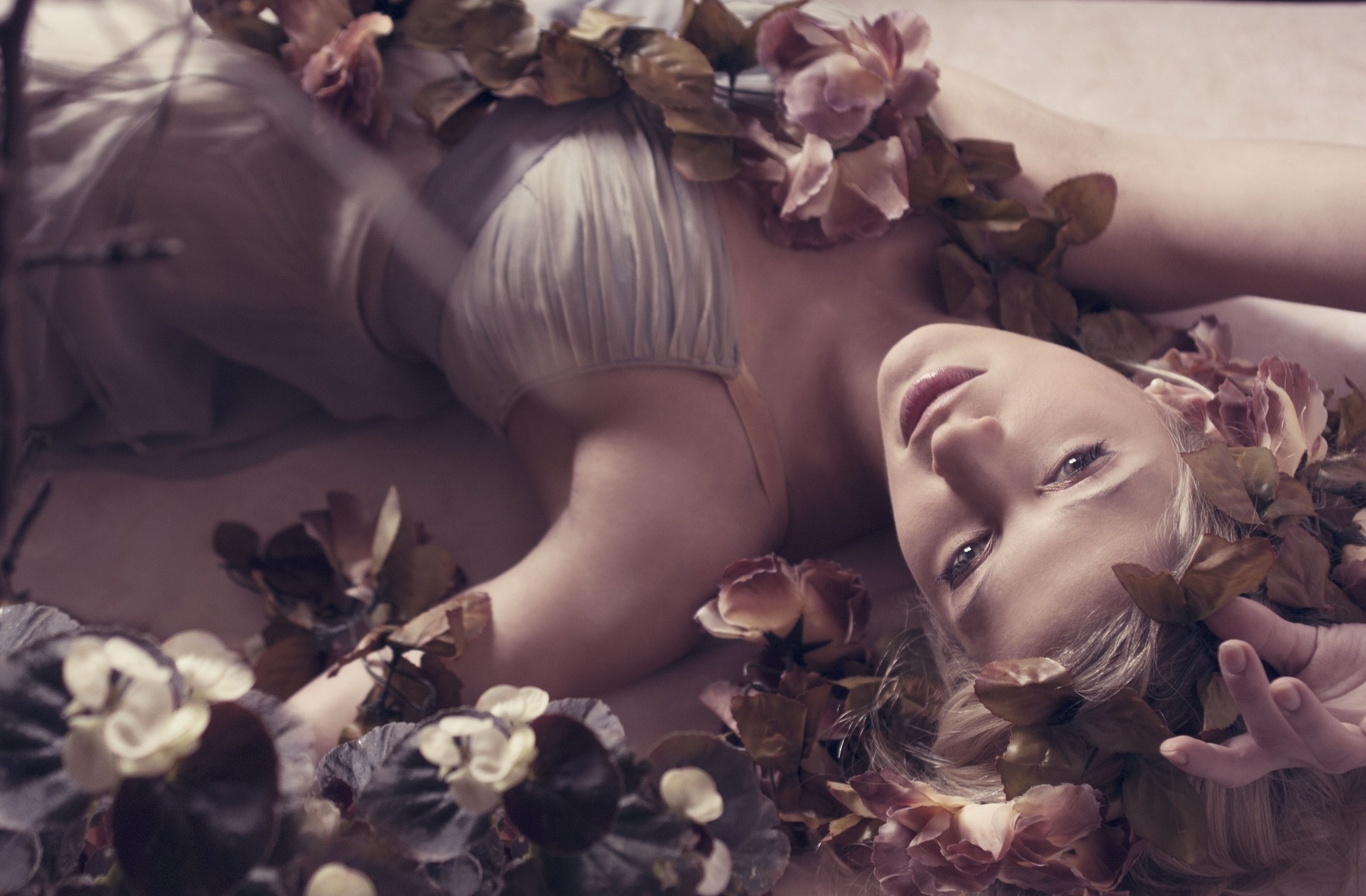 Woman adorned with flowers lying down HD Wallpaper