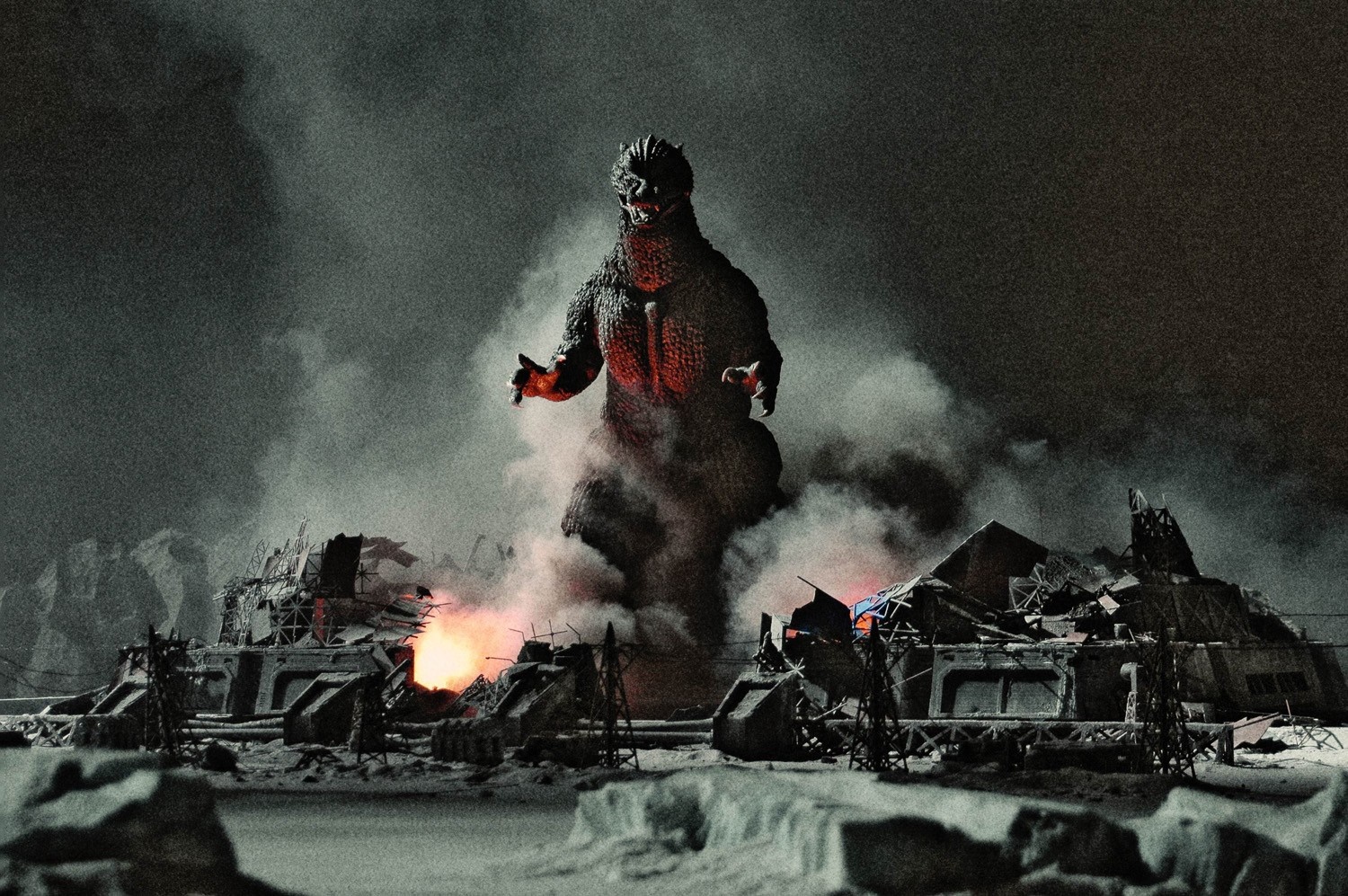 Godzilla in a destroyed city with fire and smoke HD Wallpaper