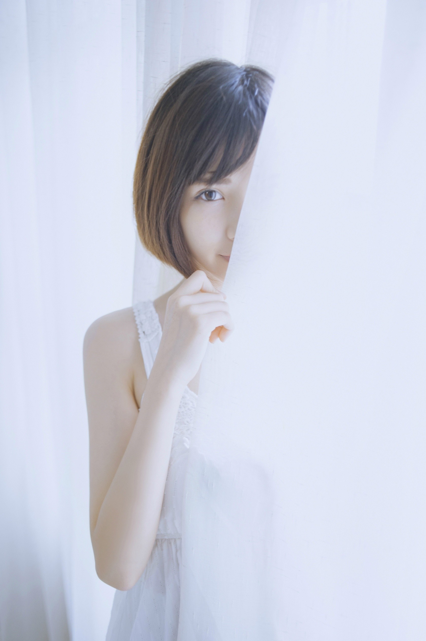 Woman peeking through white curtains HD Wallpaper