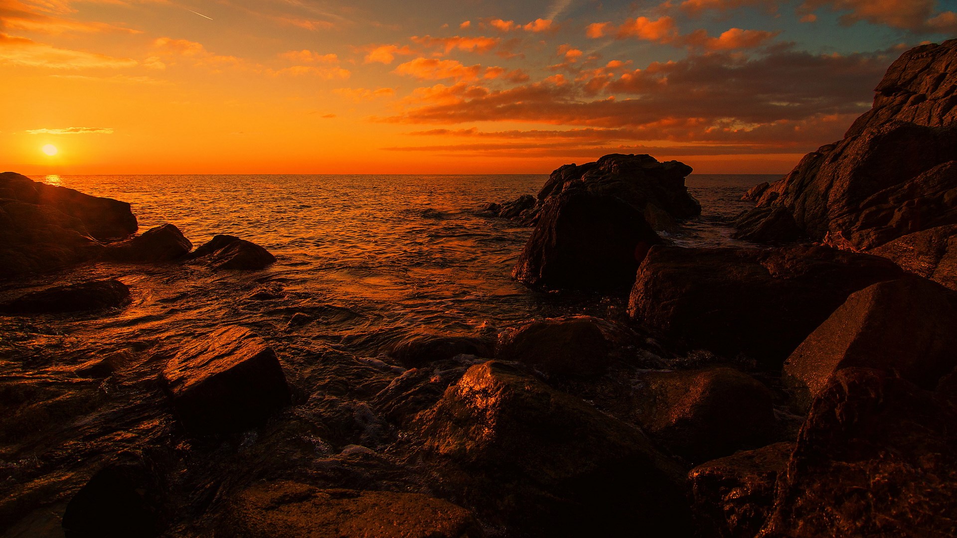 Sunset over the ocean with rocky shore HD Wallpaper