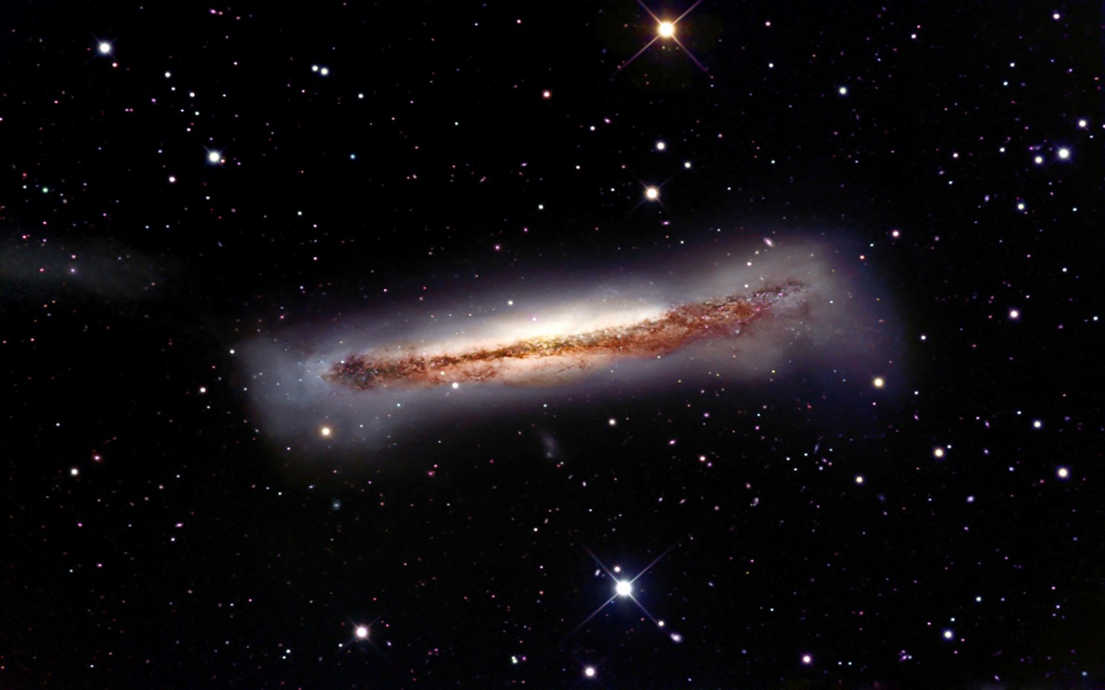 Edge-on spiral galaxy with dust lanes and stars HD Wallpaper