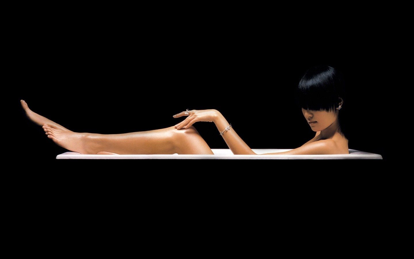 Woman in bathtub with dark hair and jewelry HD Wallpaper