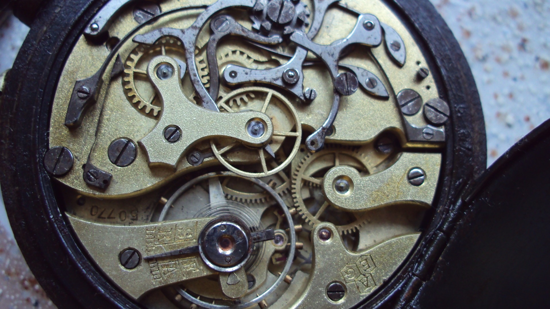 Close-up of a vintage pocket watch mechanism HD Wallpaper