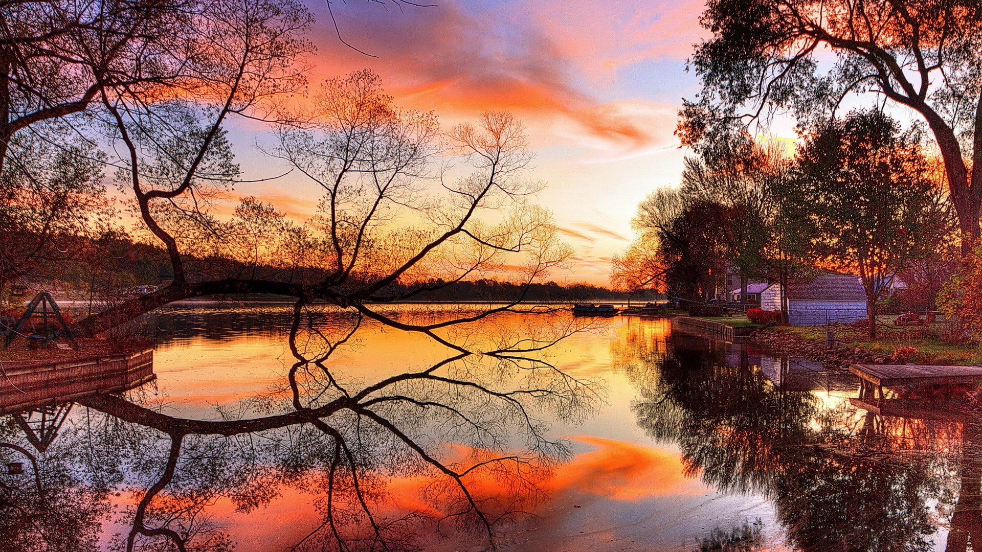 Sunset over a calm lake with trees and reflections HD Wallpaper