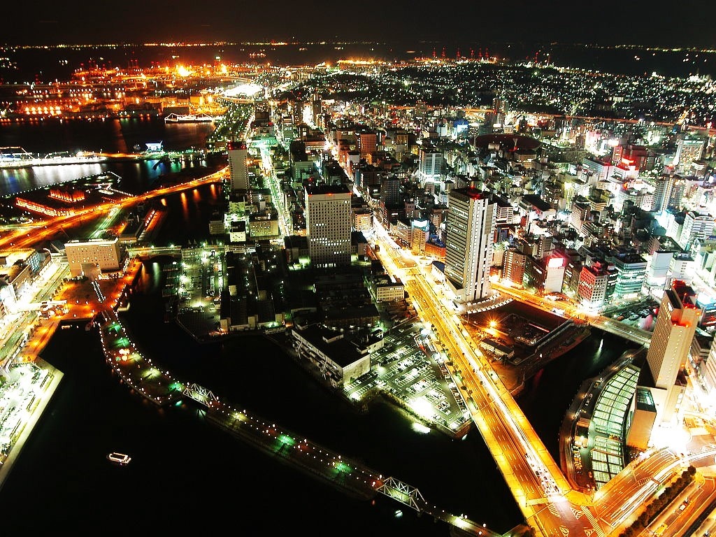 Yokohama cityscape at night with illuminated buildings and roads HD Wallpaper
