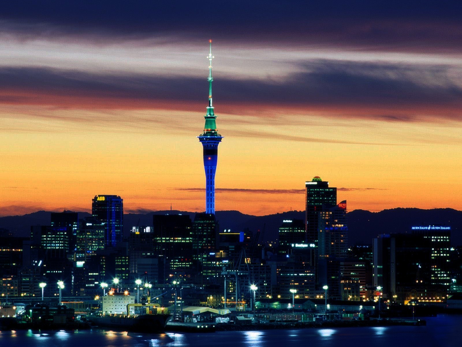 Auckland Sky Tower cityscape at sunset with harbor lights HD Wallpaper