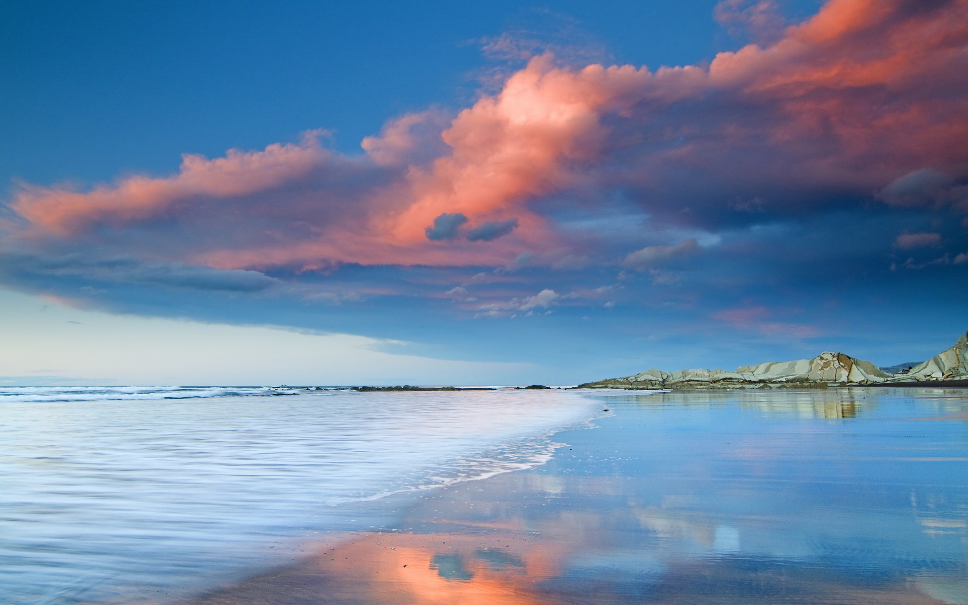 Sunset clouds over a reflective beach and ocean HD Wallpaper