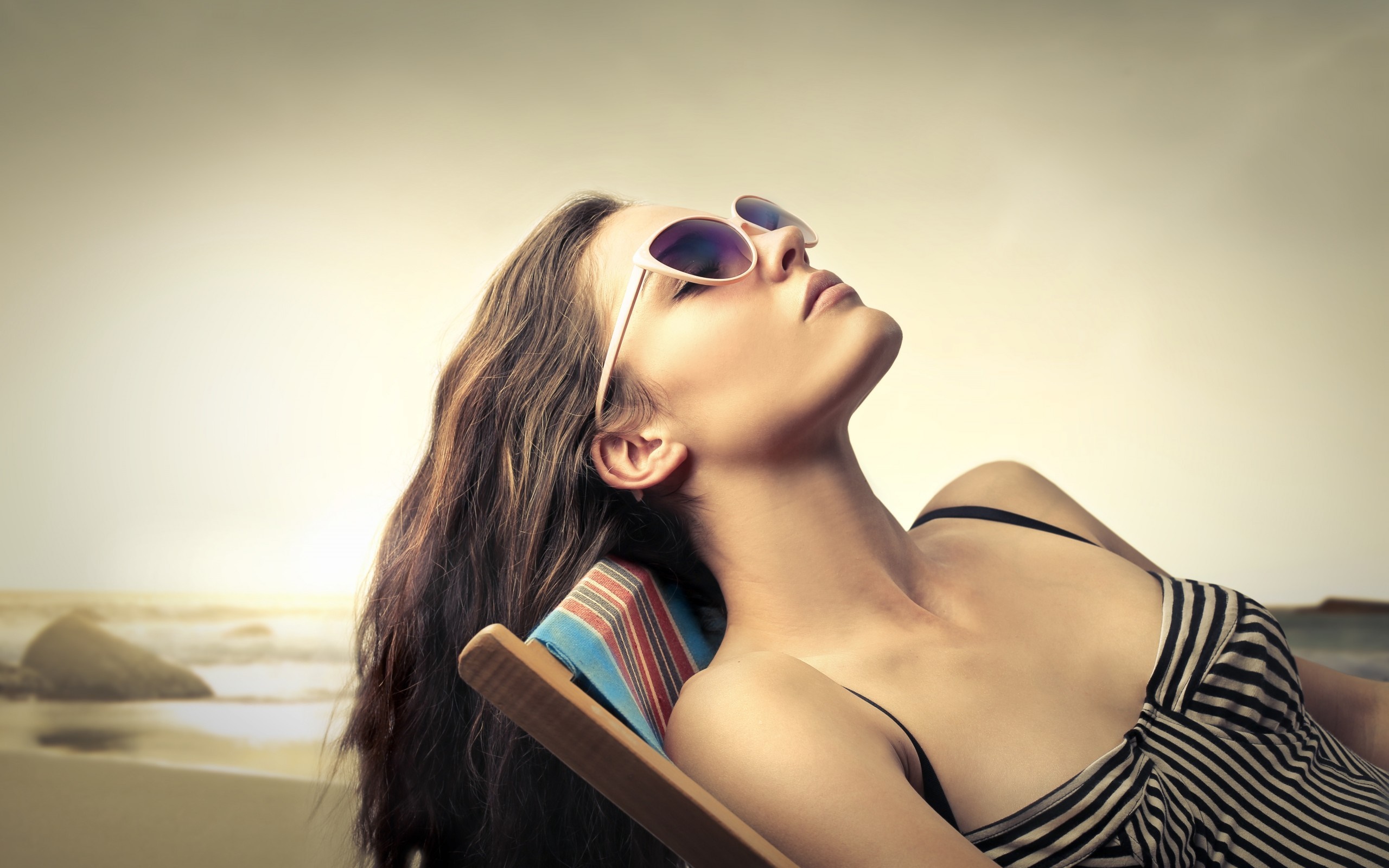 Woman in sunglasses sunbathing on a beach chair HD Wallpaper
