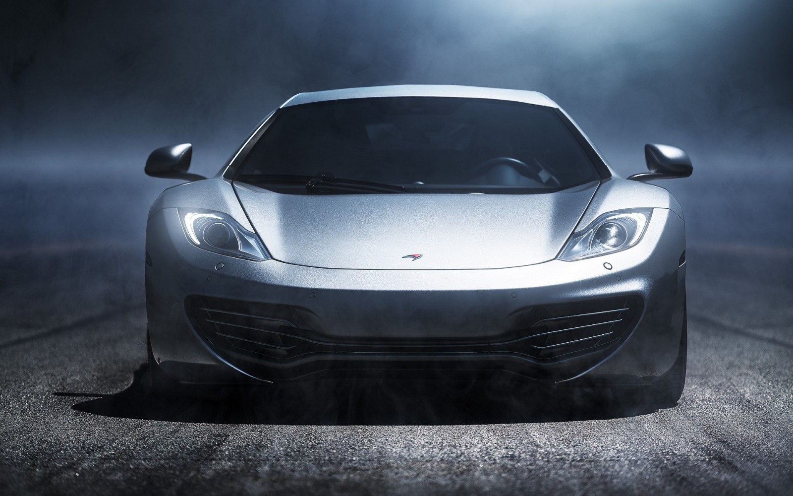 Silver McLaren MP4-12C sports car on a road HD Wallpaper