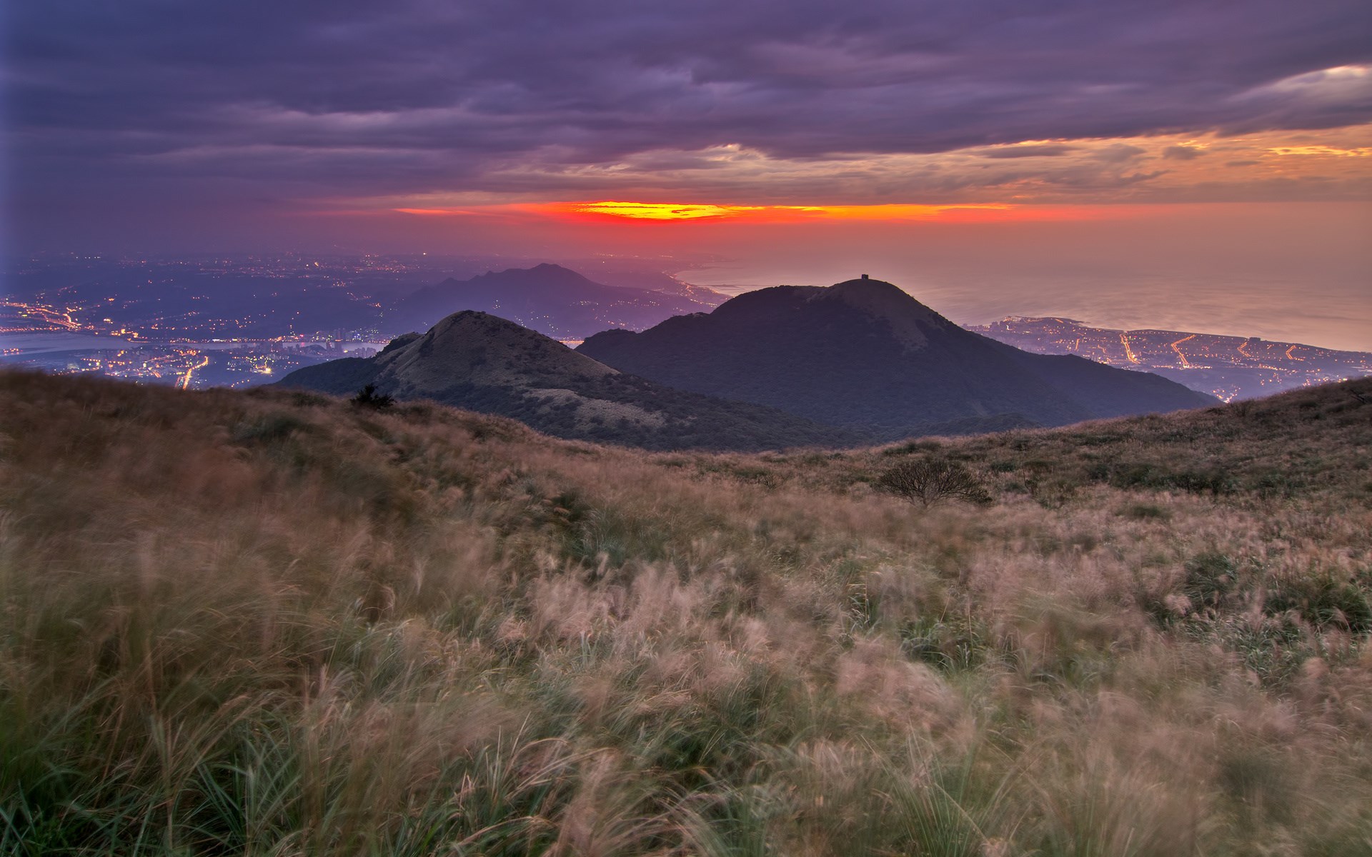 Mountain landscape with city lights at sunset HD Wallpaper