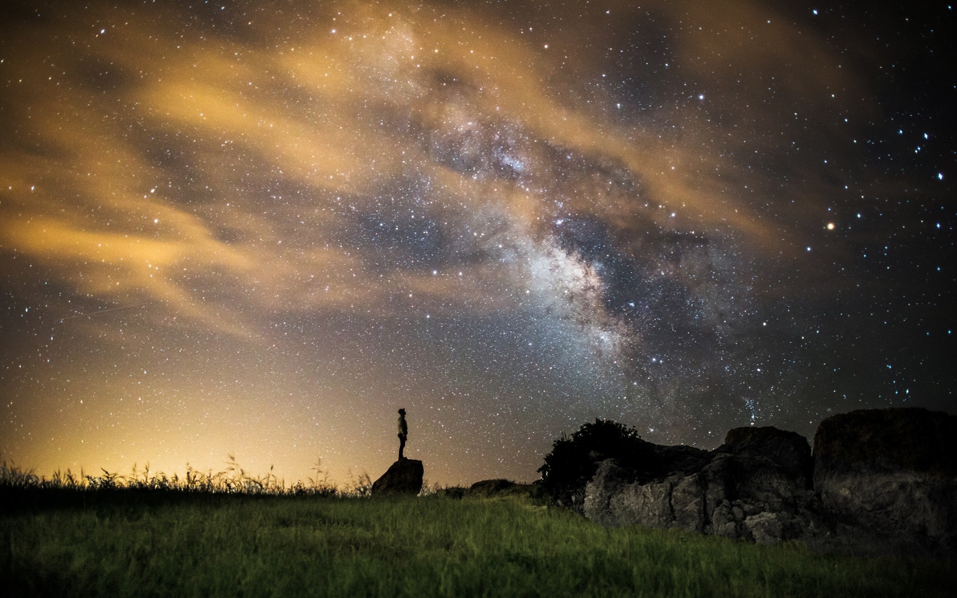 Person standing on rock under Milky Way galaxy HD Wallpaper