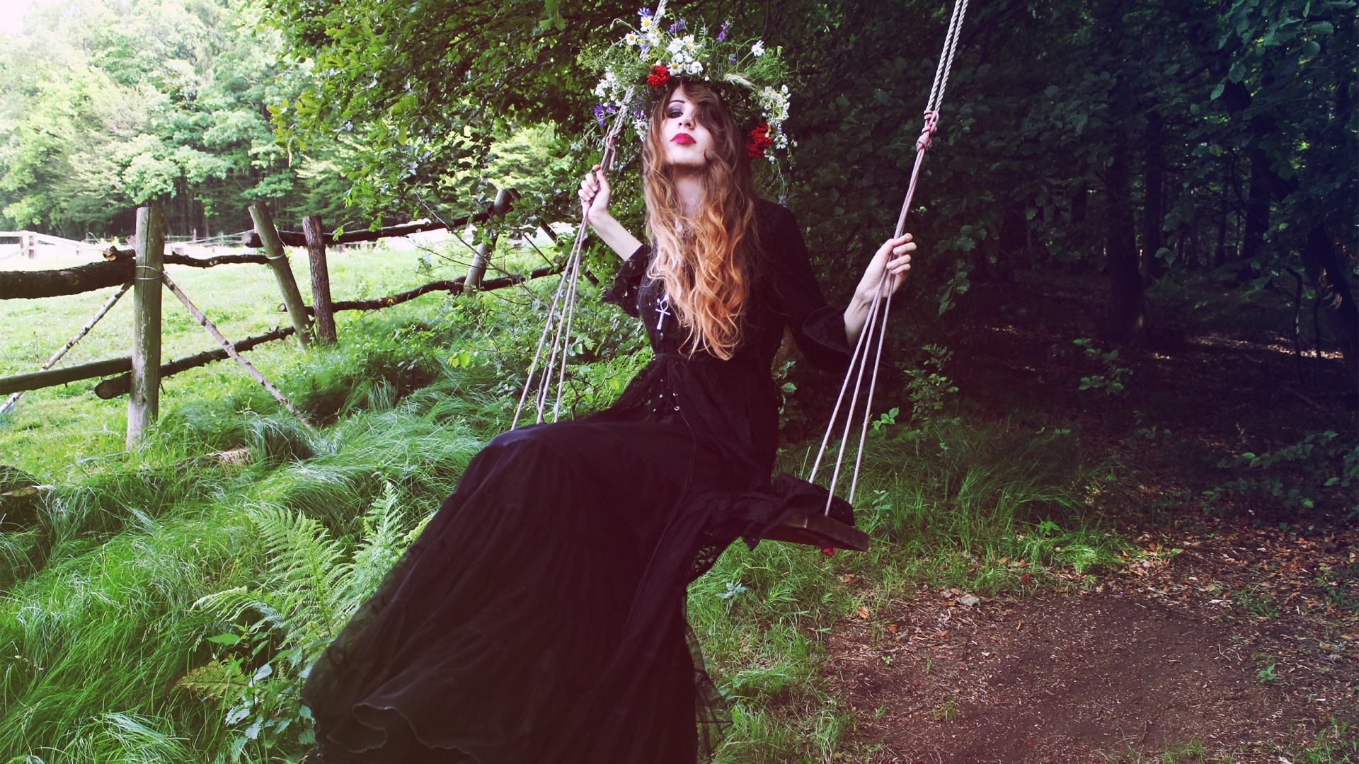 Woman with flower crown on a swing in a forest HD Wallpaper