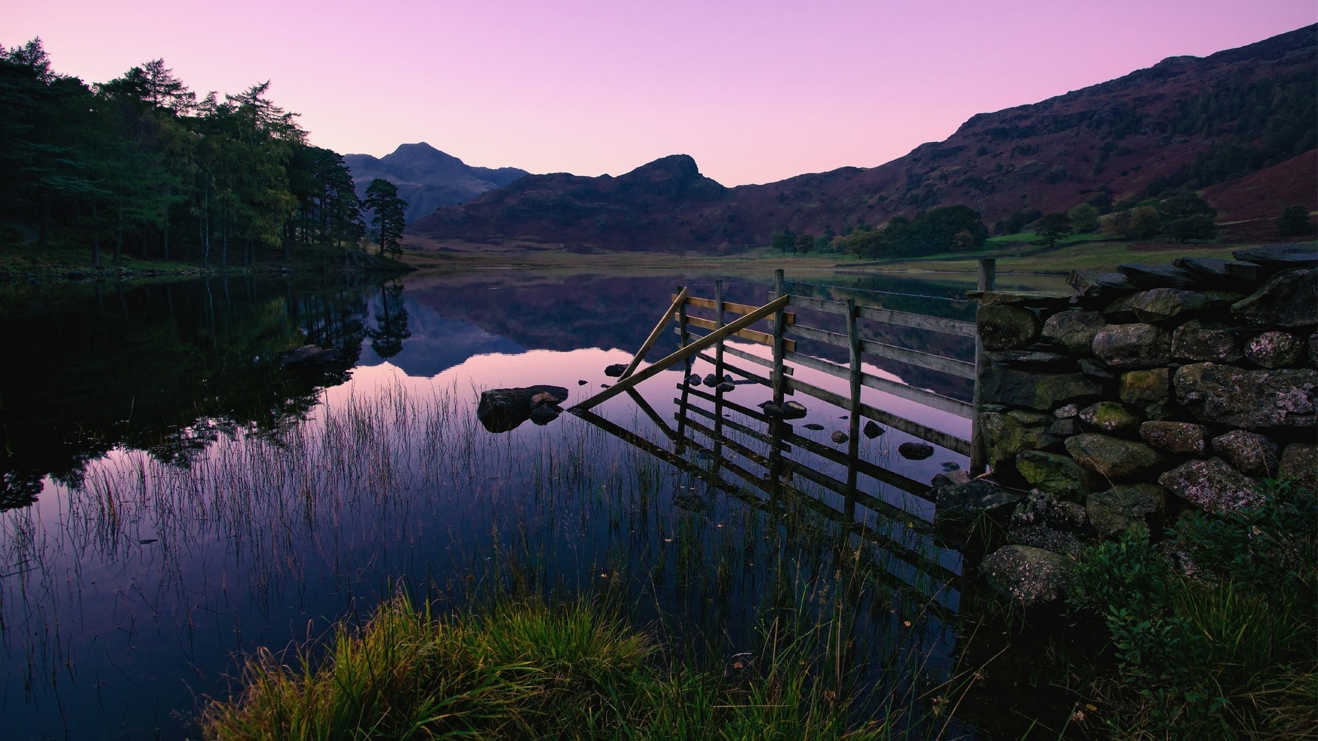 Lake and mountains at sunset with wooden fence HD Wallpaper