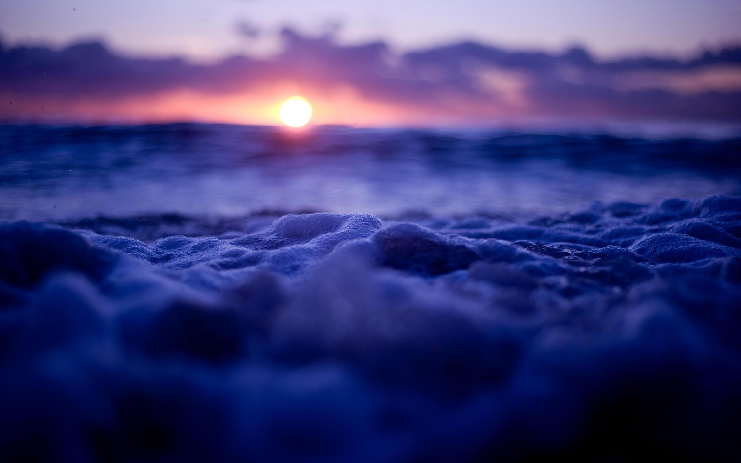 Sunset over the ocean with sea foam HD Wallpaper