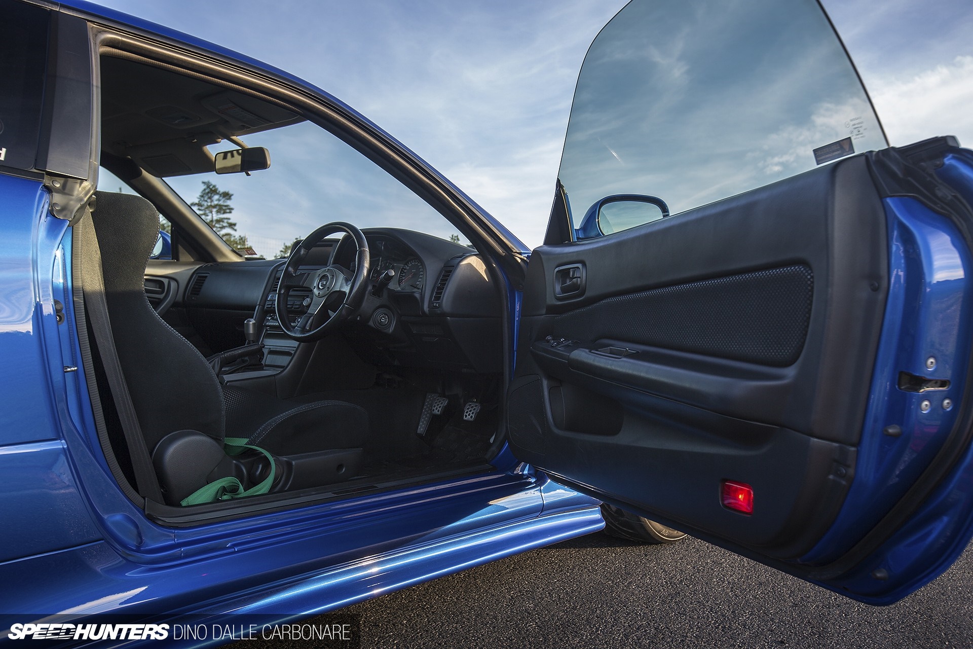 Blue sports car interior with open door HD Wallpaper