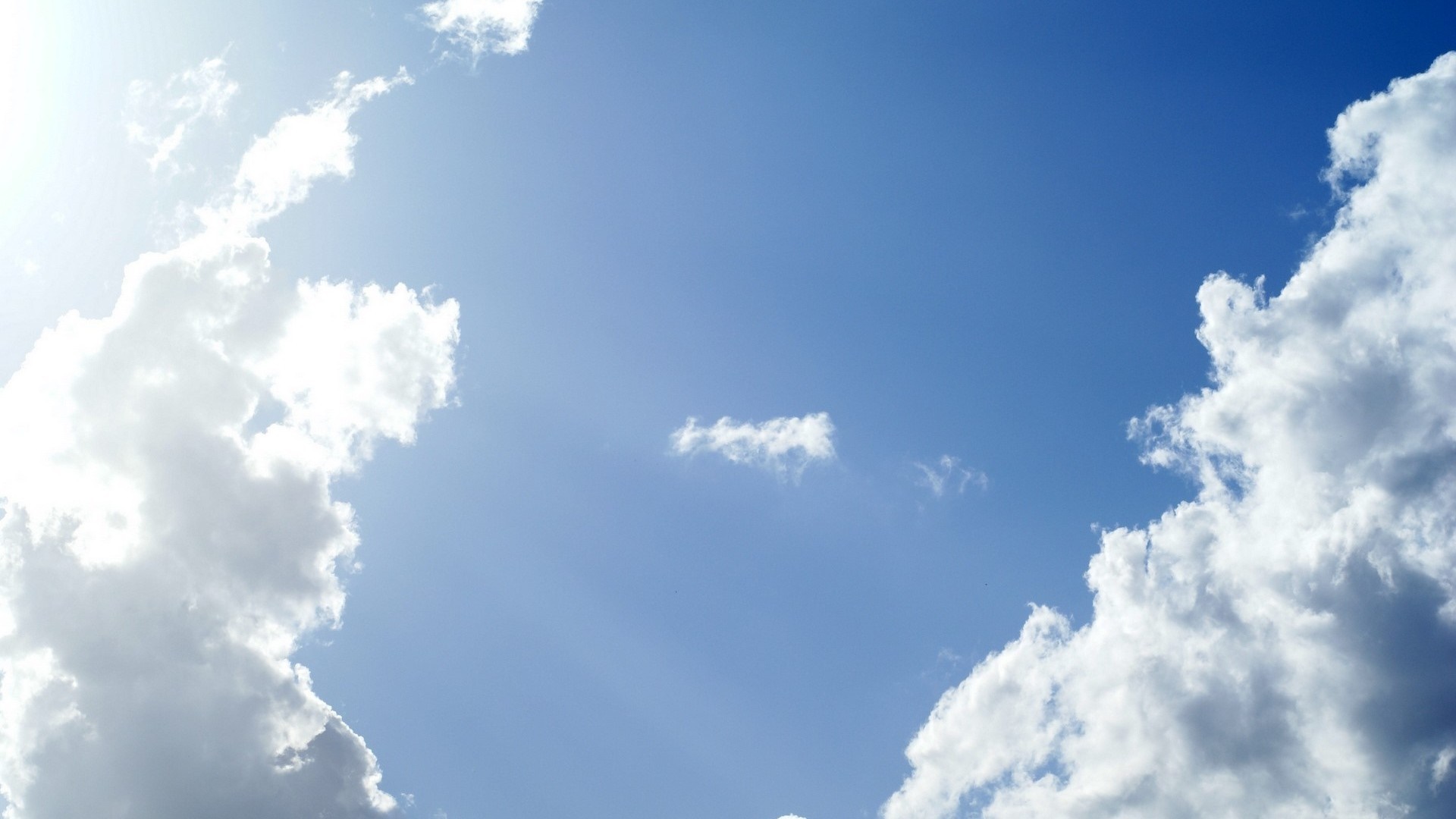 Blue sky with white cumulus clouds and sunlight HD Wallpaper