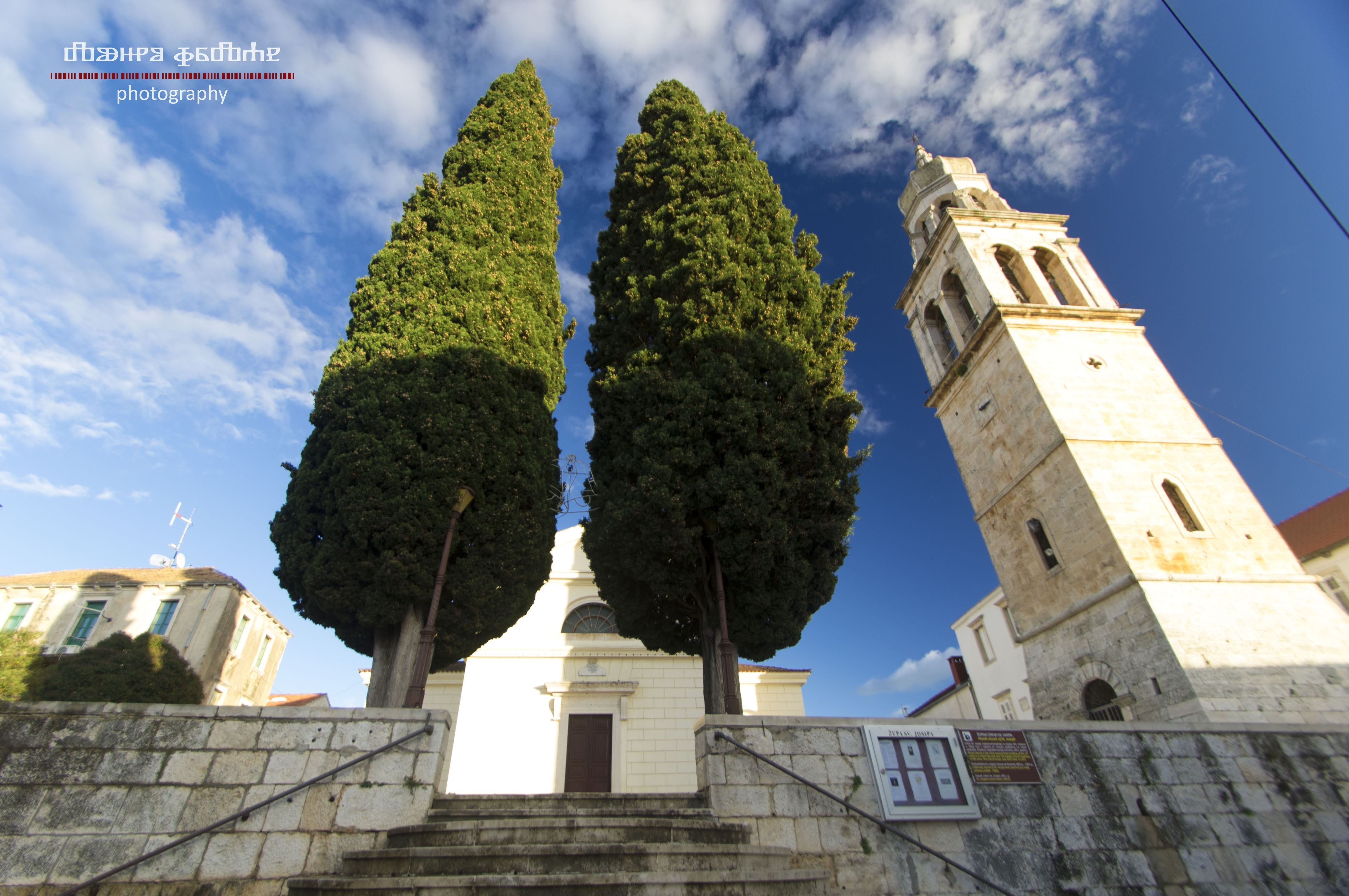 Church tower and cypress trees in Vela Luka, Korcula, Croatia HD Wallpaper