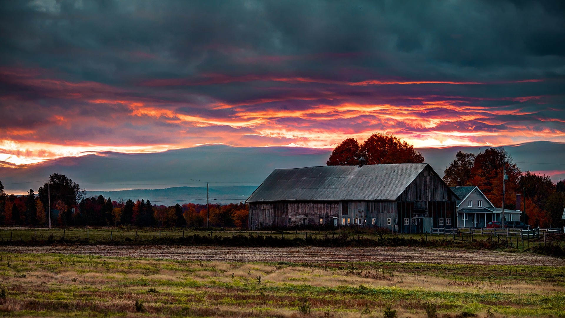 Barn and house at sunset with colorful clouds HD Wallpaper