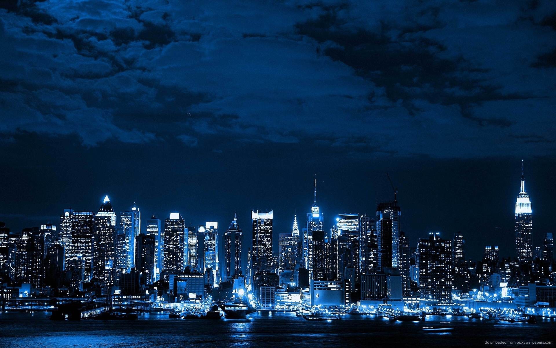 Blue toned cityscape at night with skyscrapers and clouds HD Wallpaper